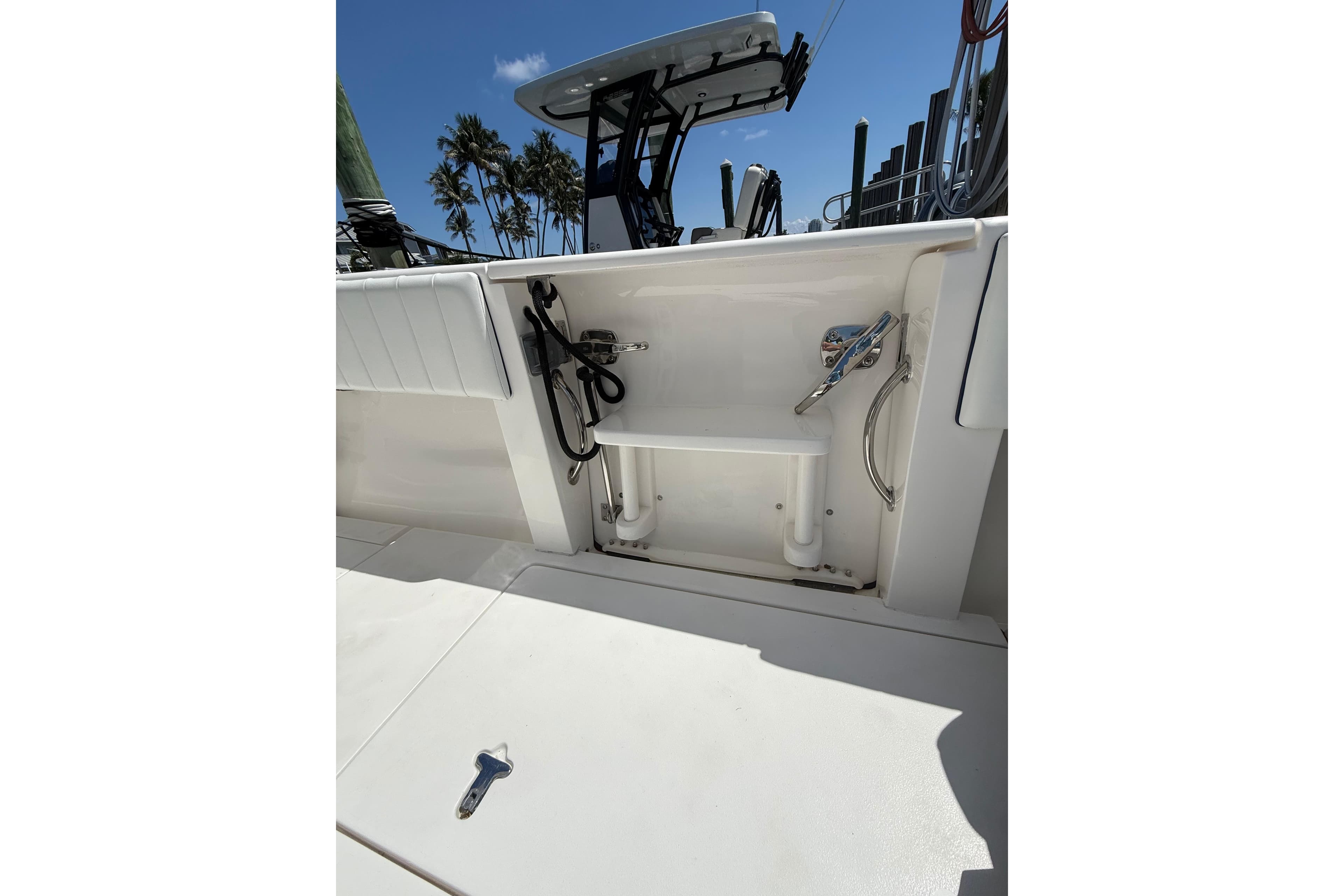 2013 Intrepid 327 Cuddy boat deck with storage compartment and equipment.