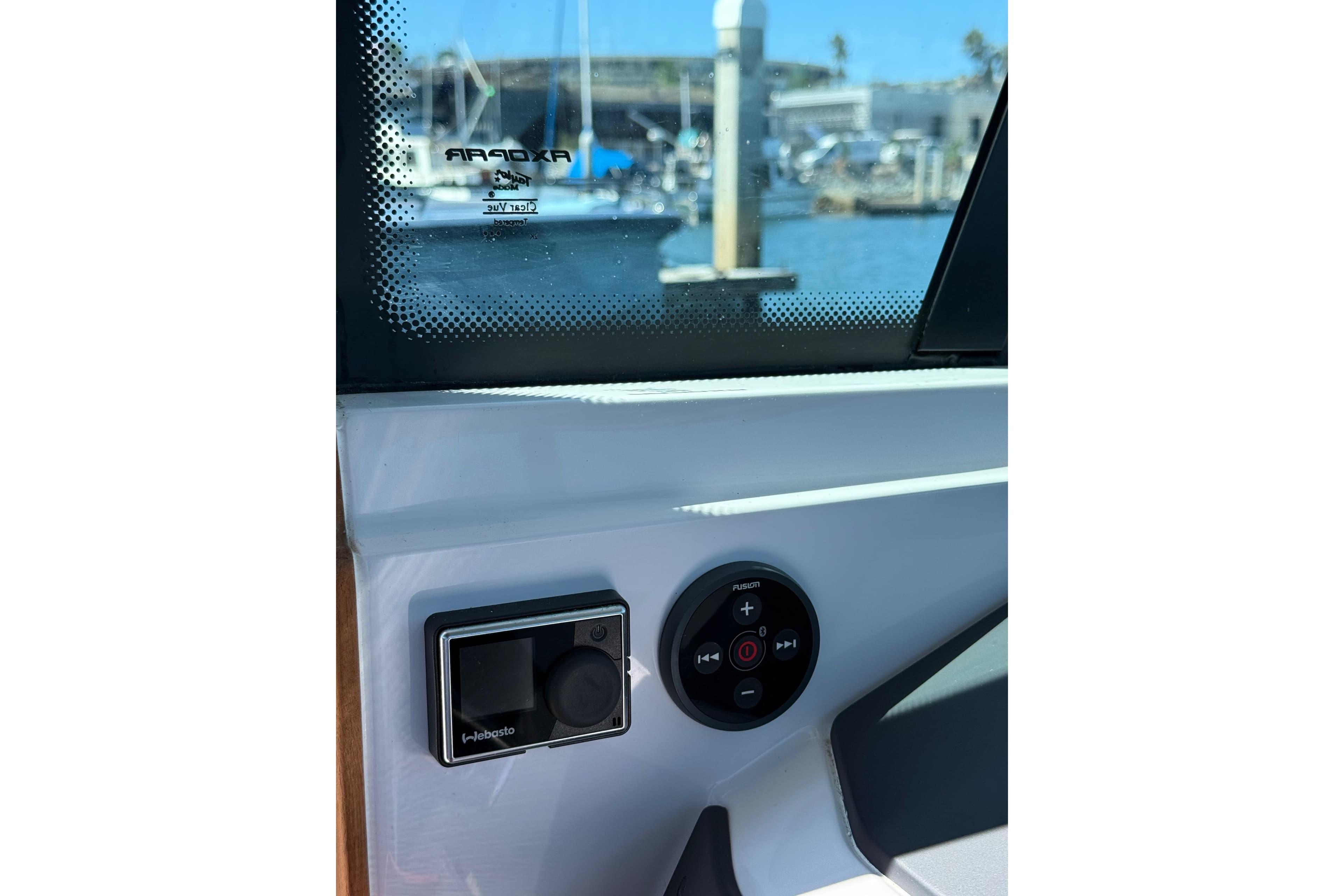 2021 Axopar 28 Cabin BRABUS Trim interior controls with marina view.