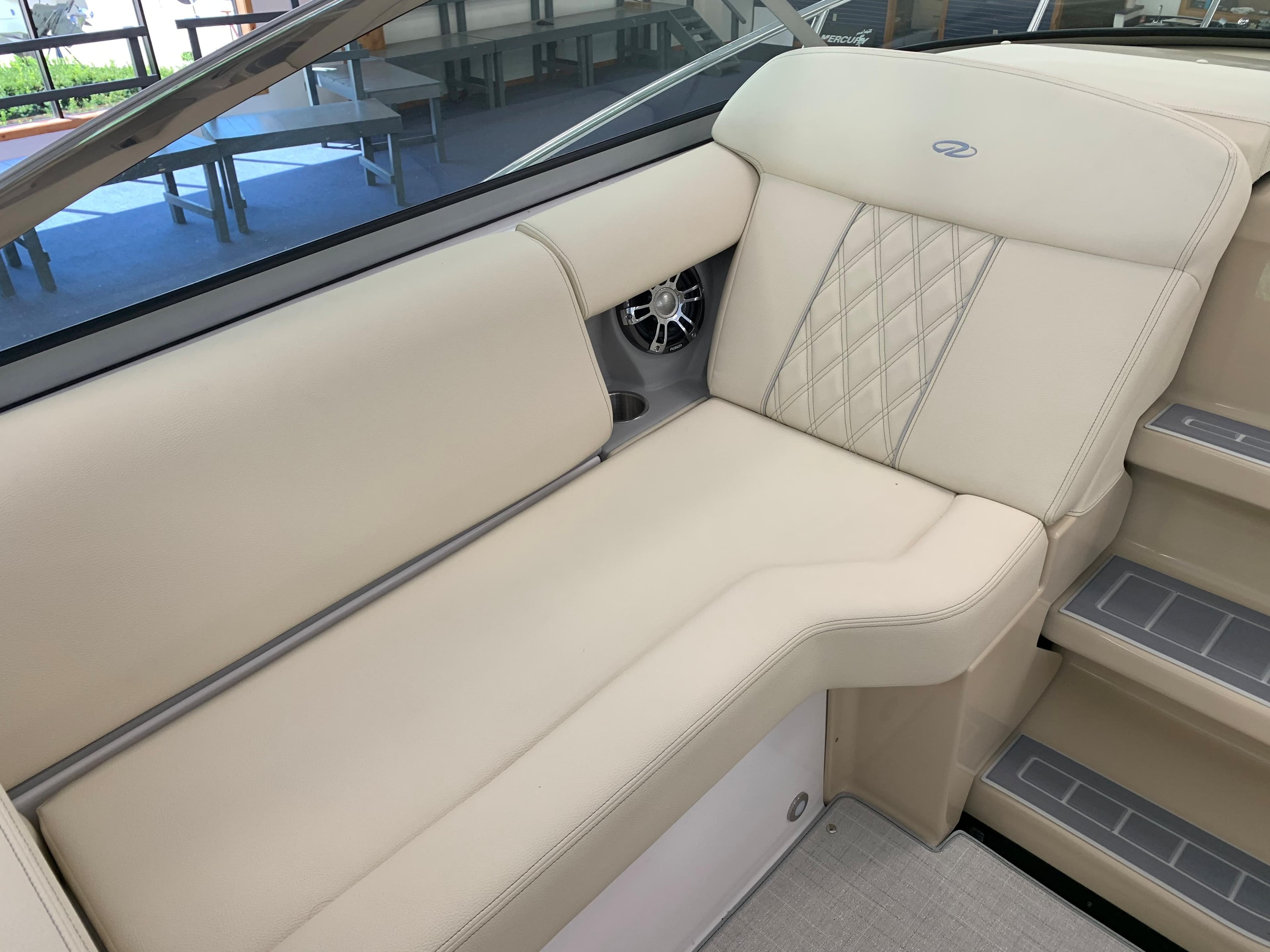 2021 Regal 33 Express boat interior with beige seating and diamond stitching.