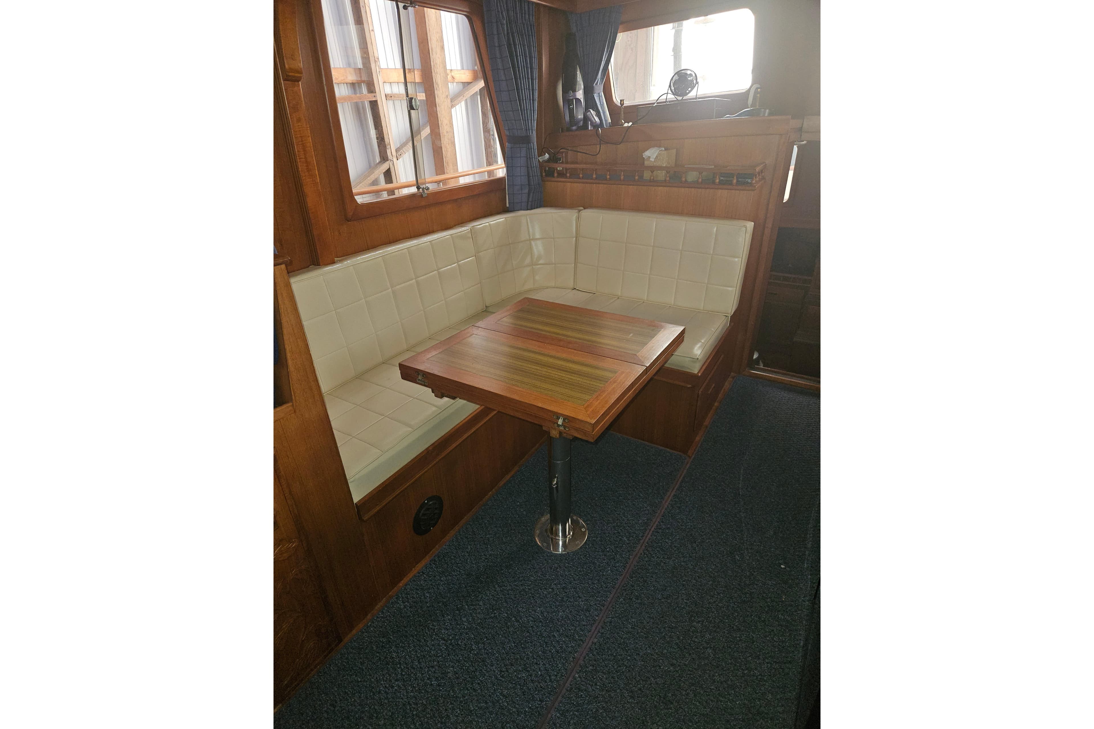 1978 CHB 34 boat interior with wooden table and cushioned seating.