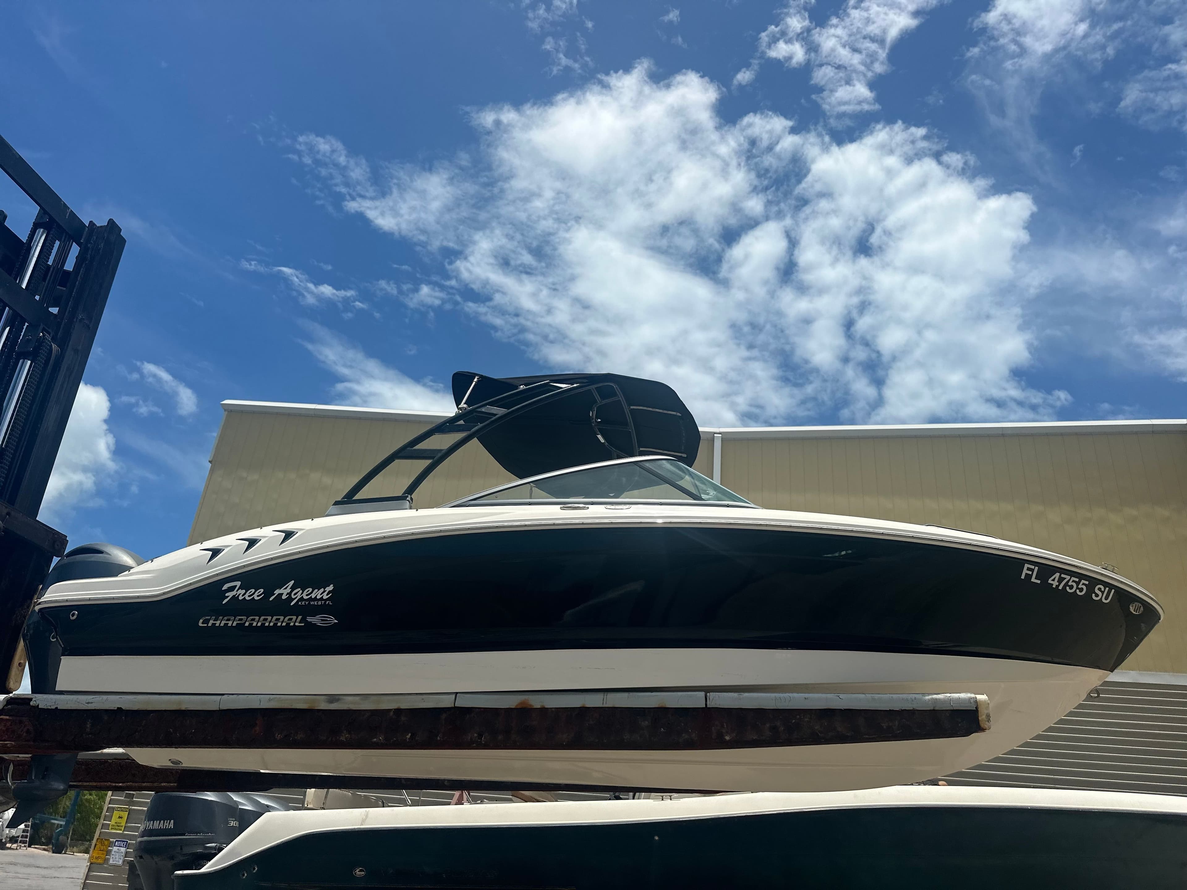 2021 Chaparral 21 SSi boat against blue sky.