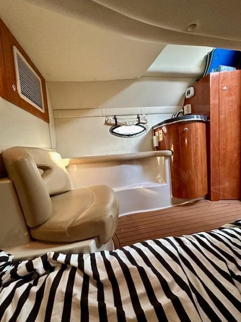 Interior of a 2006 Doral Elegante boat with seating and wooden cabinetry.