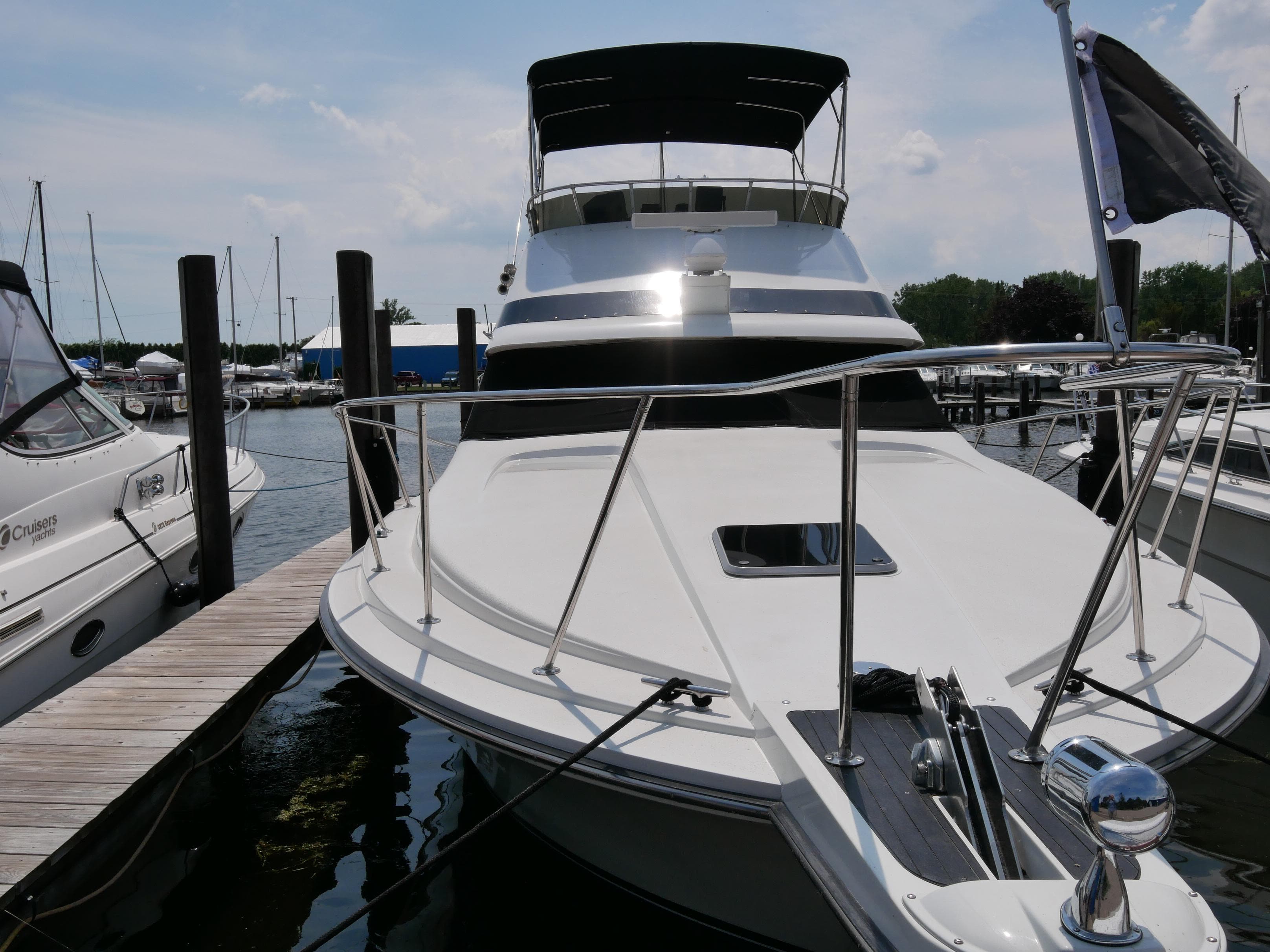 1987 Trojan 10.8 Meter Sedan yacht docked at a marina.