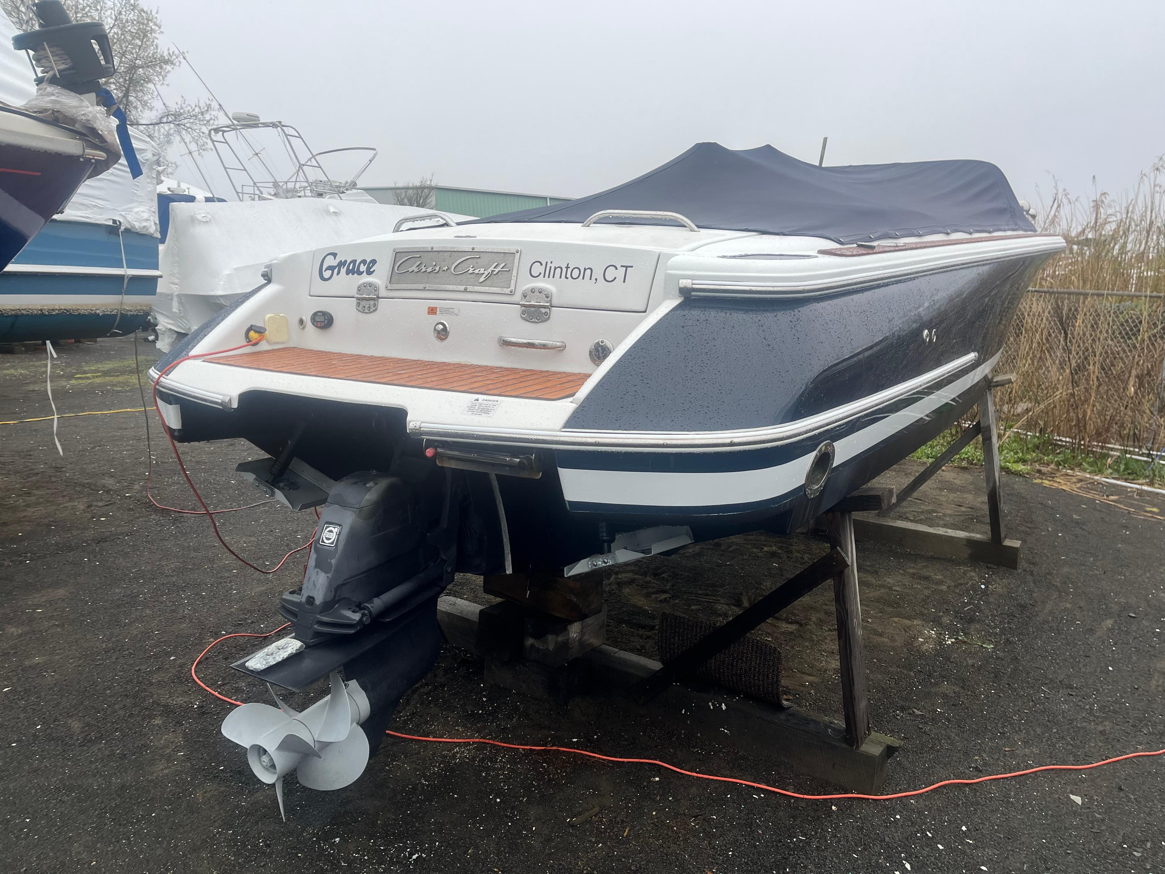 2004 Chris-Craft Corsair 25 boat on stand, rear view, covered, Clinton, CT.