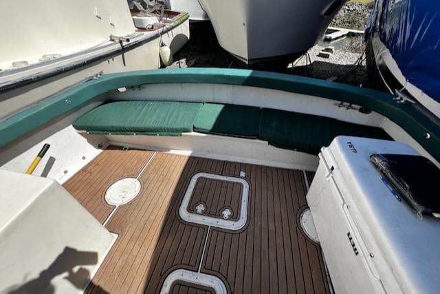 1978 Bruno & Stillman Custom Cruiser/Sportfisherman boat interior with green seating and wooden deck.