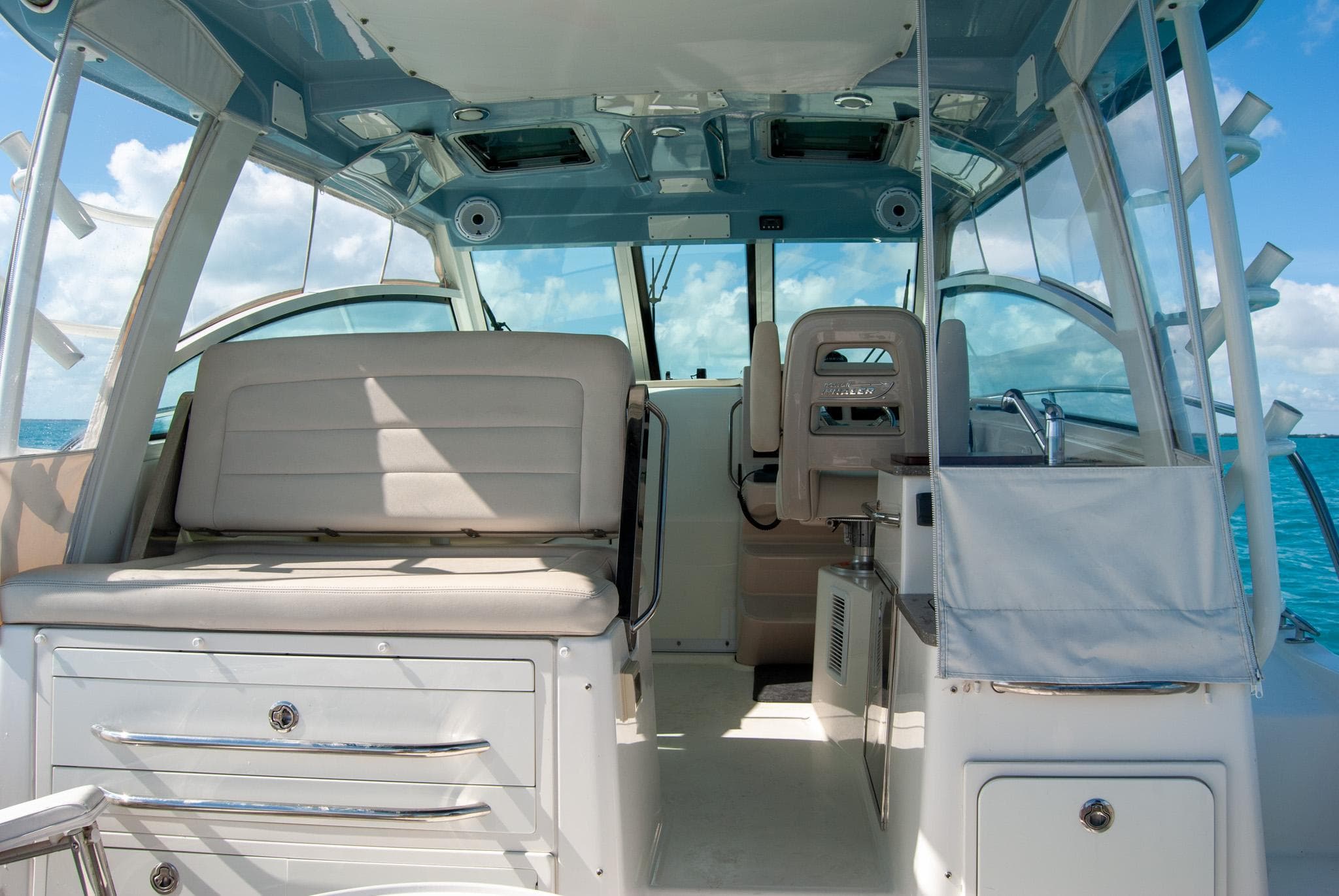 2021 Boston Whaler 345 Conquest interior with seating and helm, under clear blue skies.