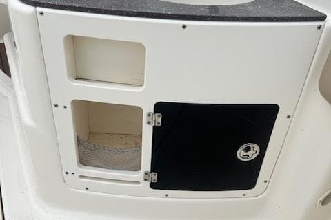 2008 Scout 242 Dorado boat storage compartment with open and closed sections.