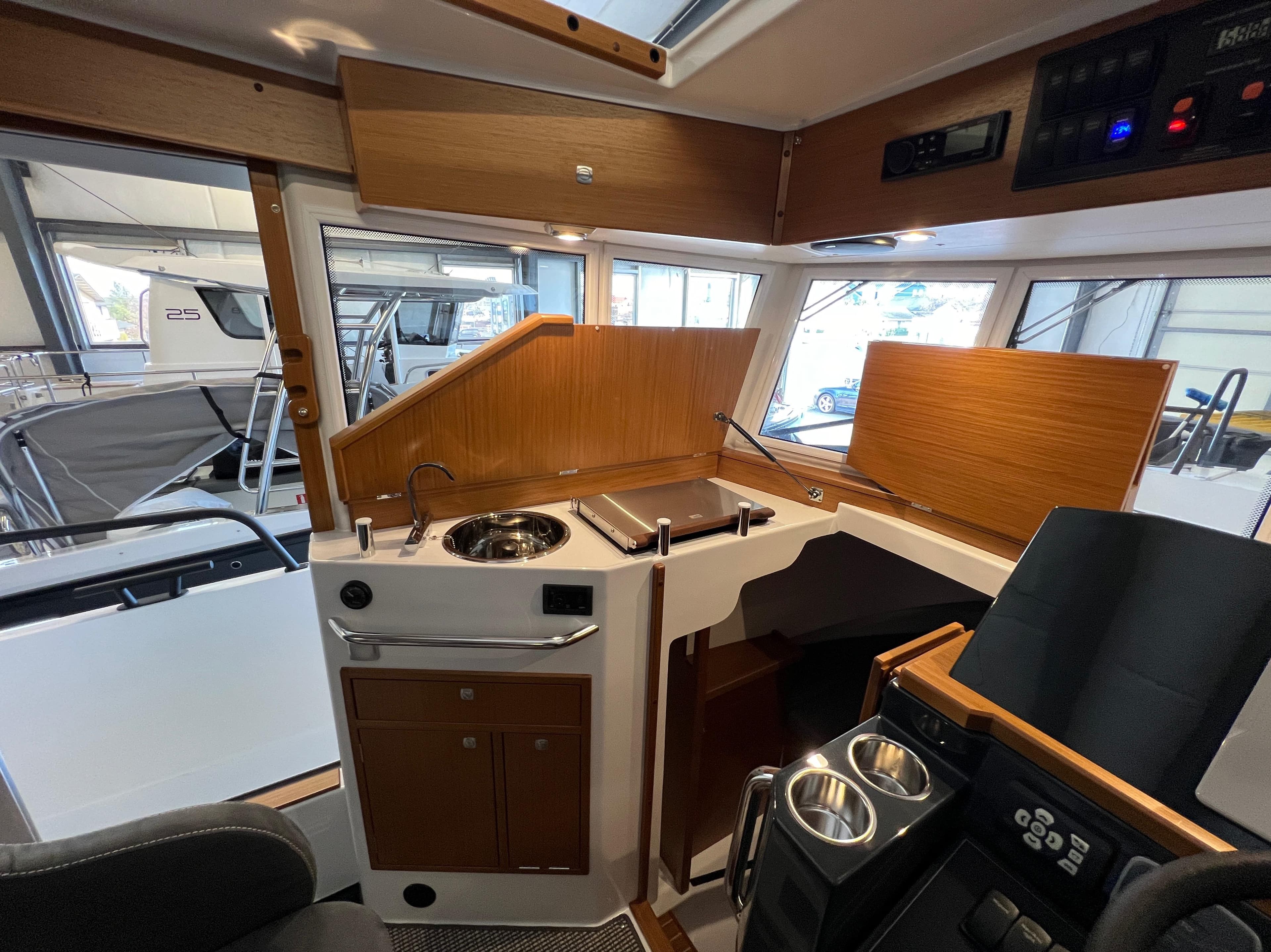 Interior of 2024 Sargo 28 boat with modern kitchen and control panel.