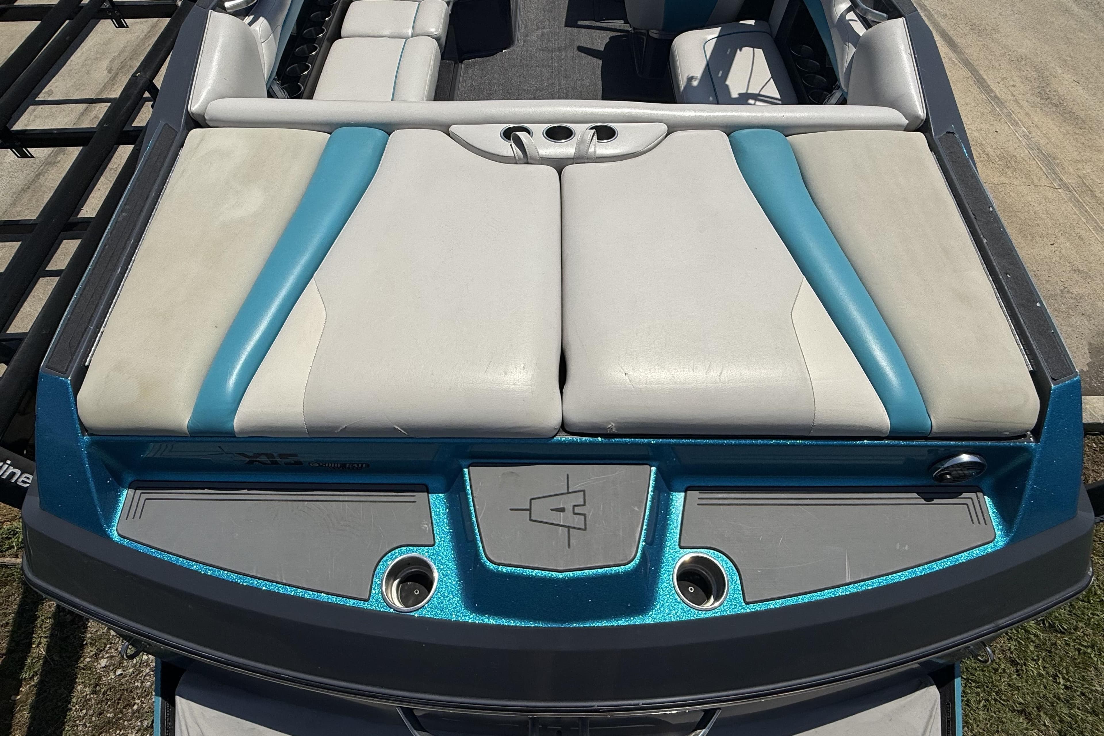 2016 Axis A22 boat with blue and white seating, rear view.