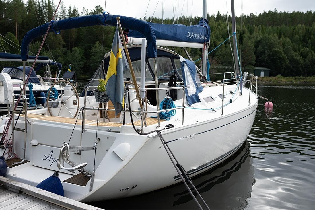 Sailboat Dufour 385, 2006 model, docked in a serene marina setting.