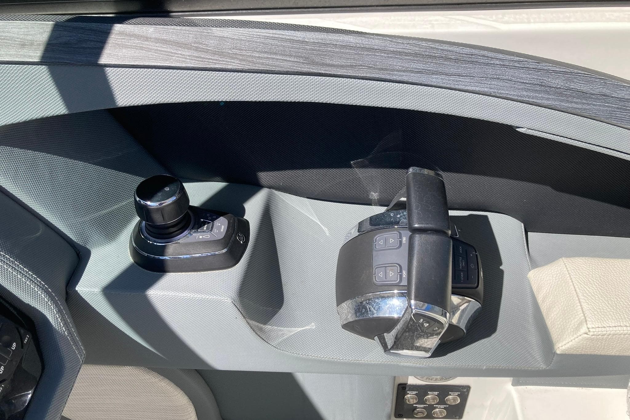 Control panel of a 2022 Cobalt R30 boat with joystick and throttle.