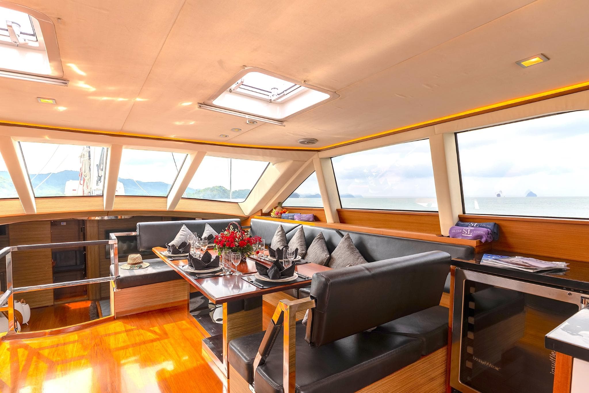 Luxurious interior of 2011 Custom Phithak - S&S 104’RS yacht with elegant seating and panoramic windows.