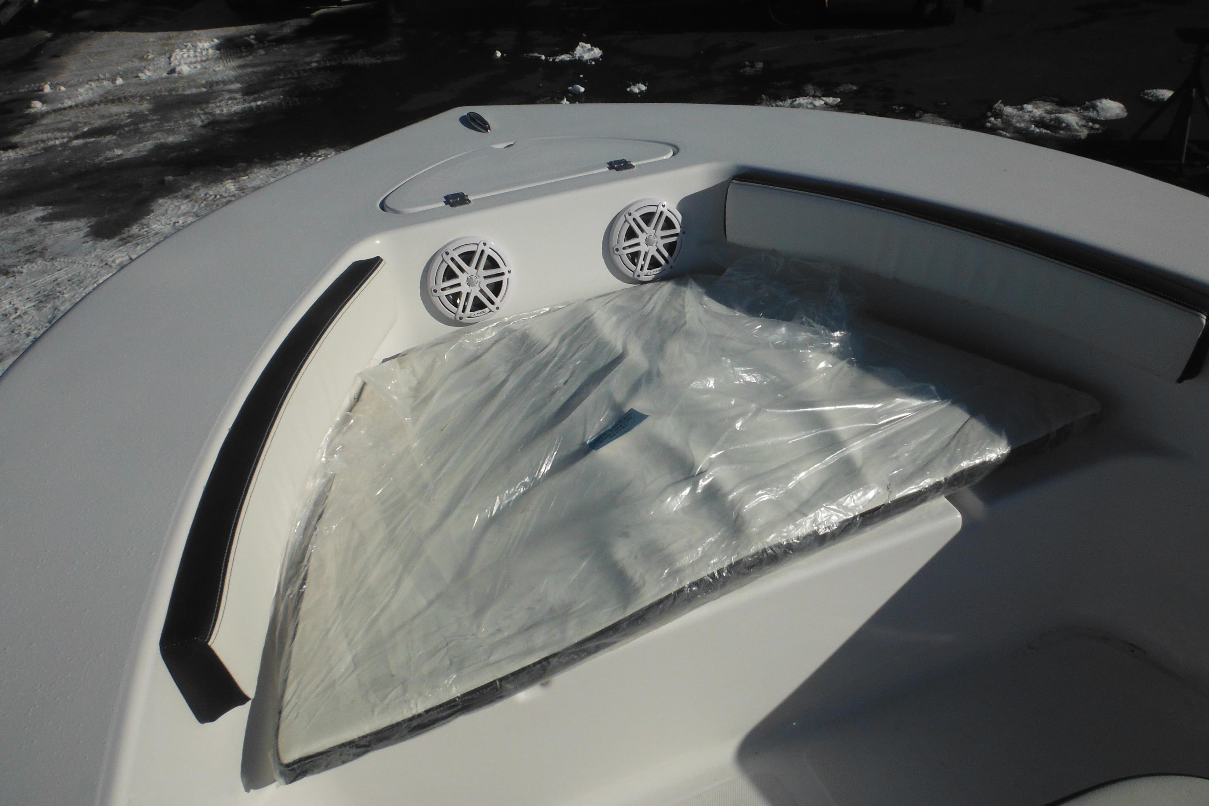 2026 Tidewater 180 CC Adventure boat interior with cushioned seating and speakers.