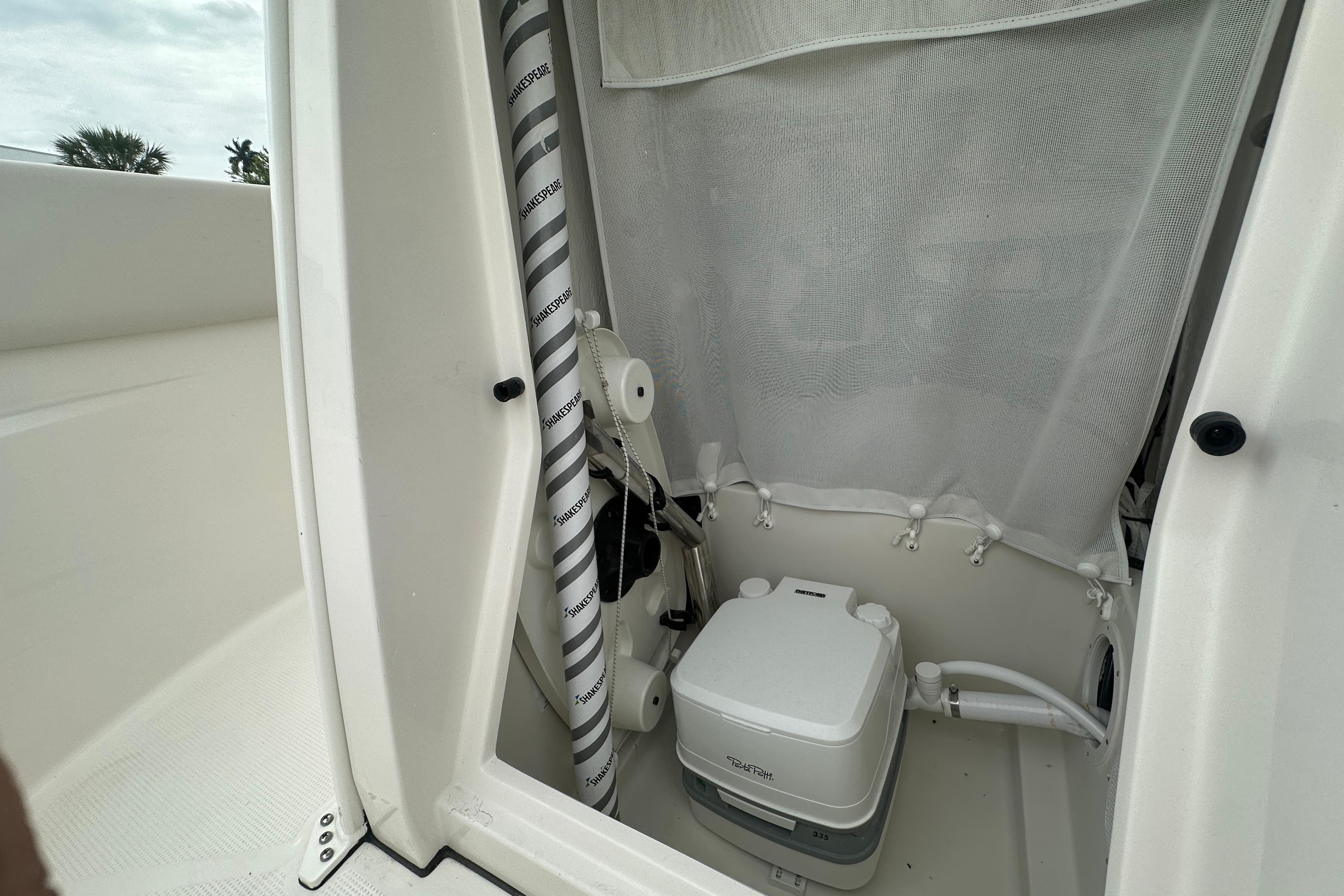 Interior of 2026 Sailfish 232 CC boat featuring a compact marine toilet.