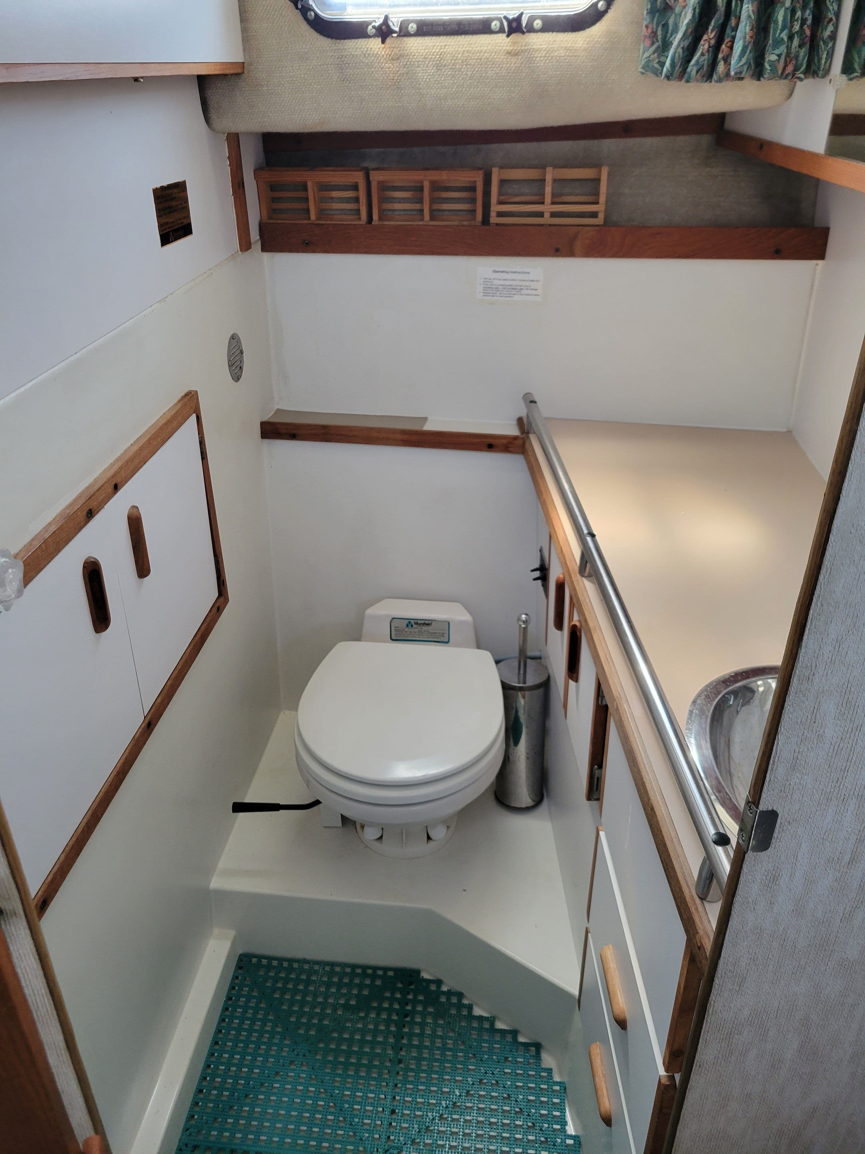 Interior of 1984 Carver 28 Riviera Diesel with toilet and sink.