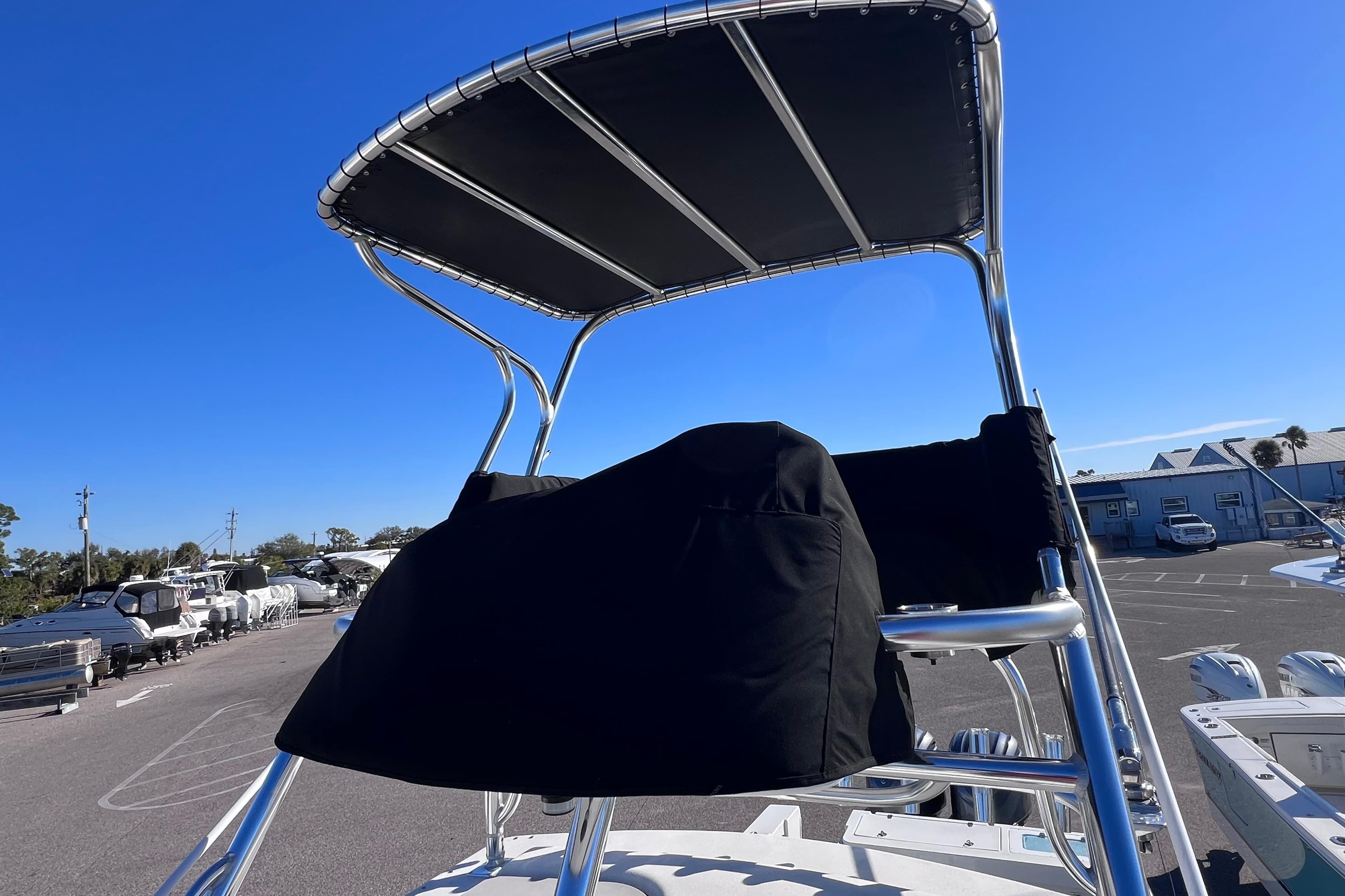 2023 Parker 2820 XLD Sport Cabin boat with T-top and covered helm station.