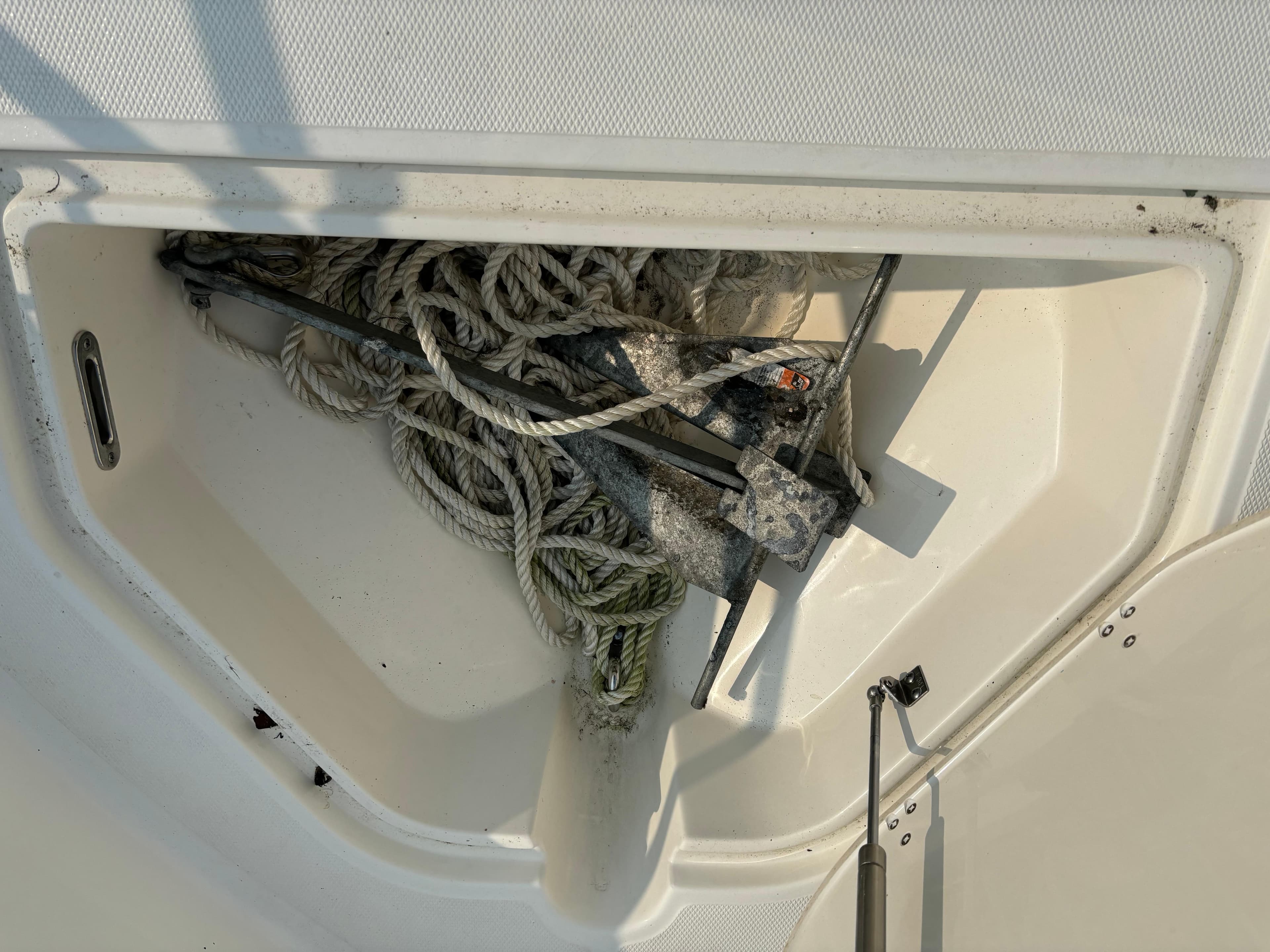 Anchor and ropes in storage compartment of 2023 Boston Whaler 250 Dauntless boat.