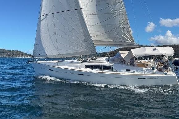Sailing yacht Beneteau 43, 2012 model, gliding on blue waters under clear skies.