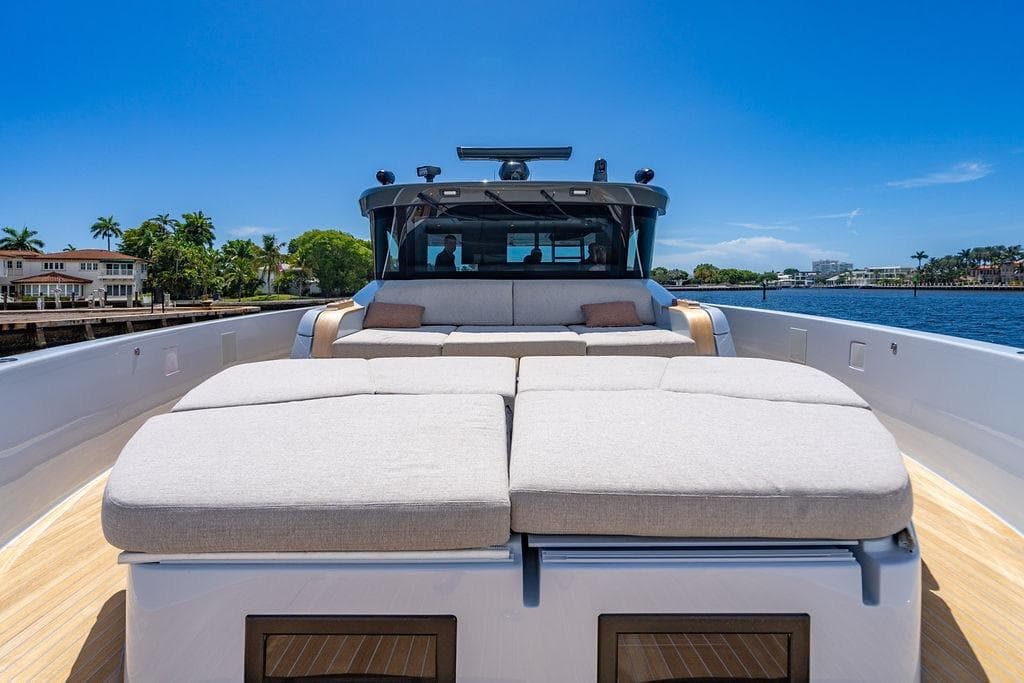 Luxurious 2023 Bluegame BG 72 yacht with spacious sunbathing deck, cruising on a sunny day.
