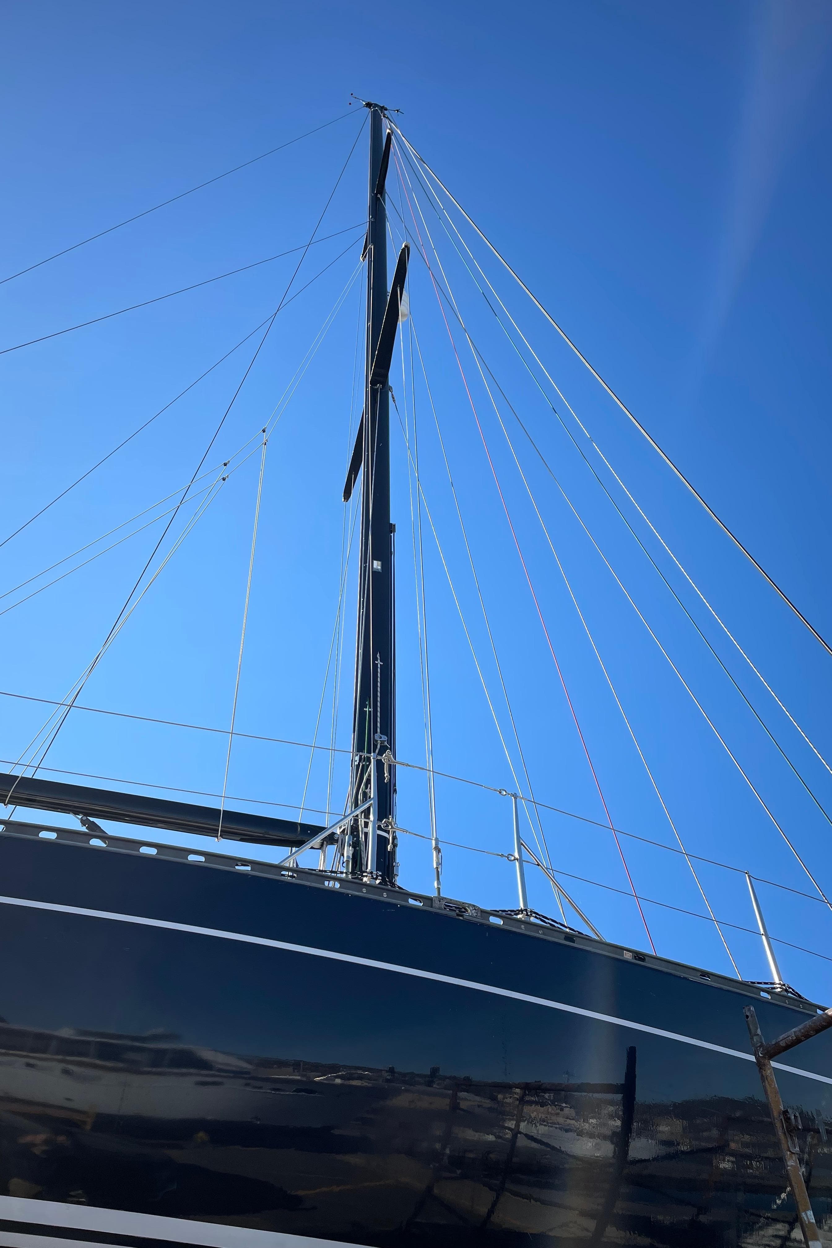 Sailboat Baltic 42, 1982 model, with tall mast against clear blue sky.