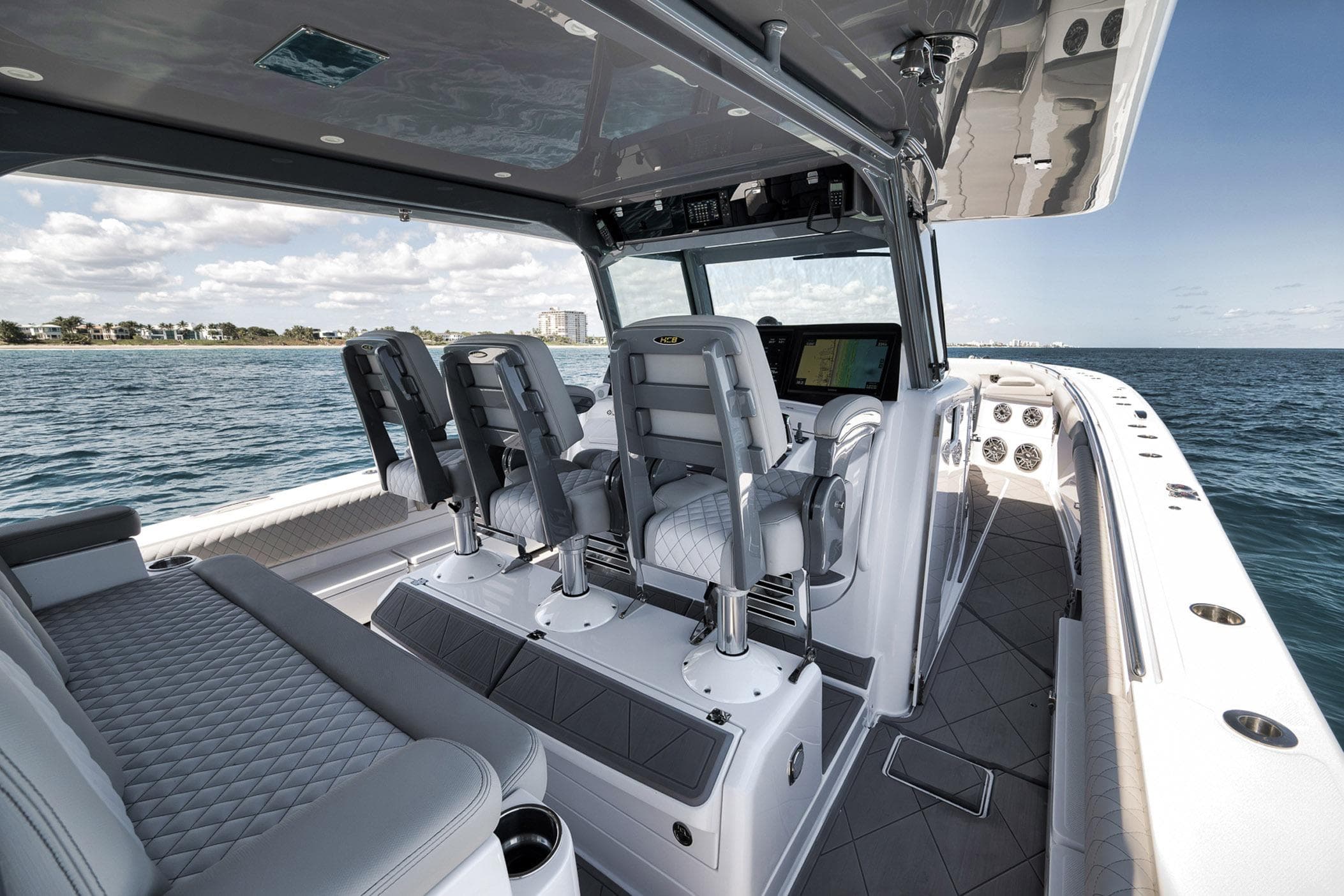 Luxurious 2025 HCB 53 Suenos boat interior with plush seating and advanced navigation system.