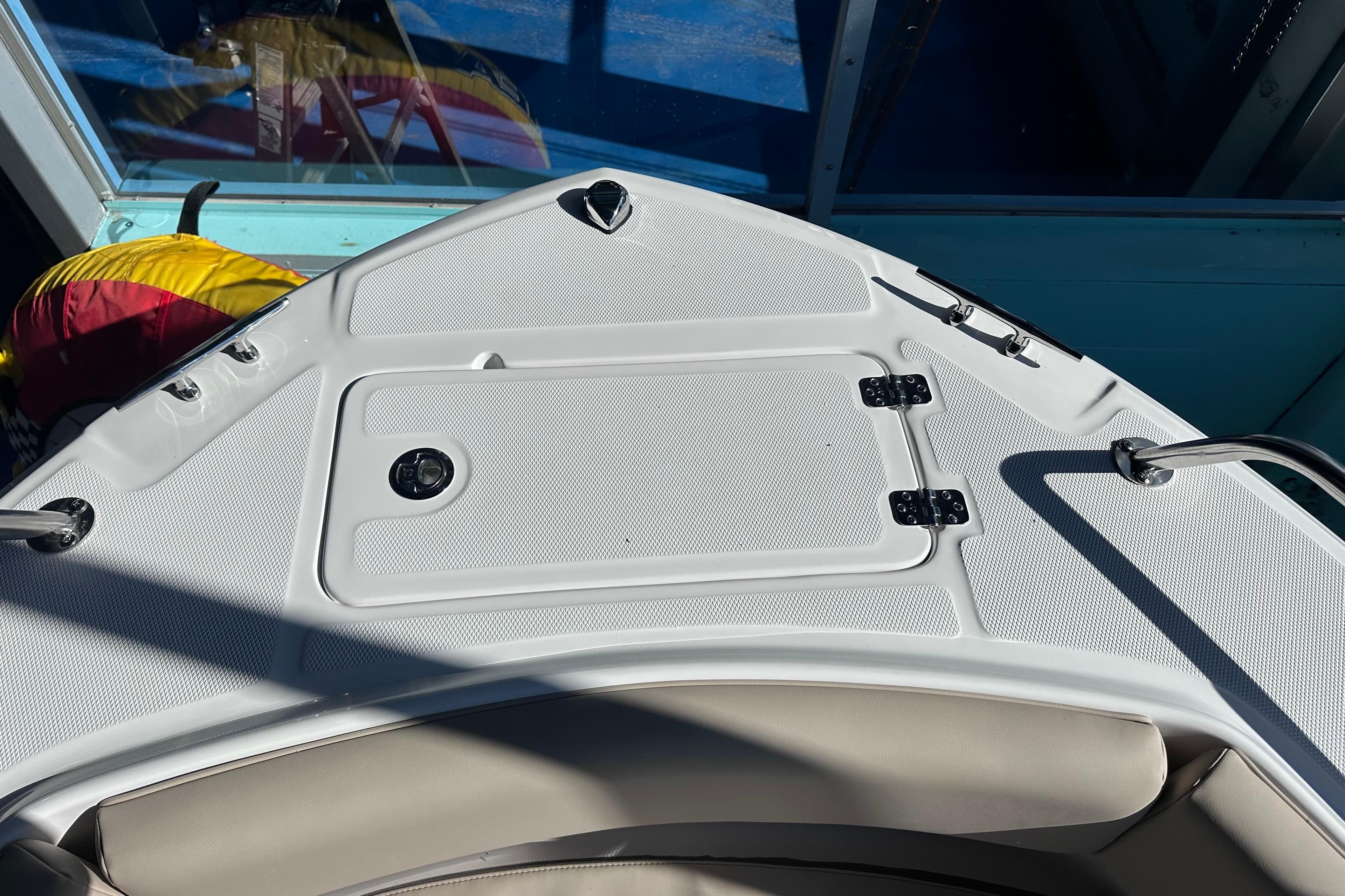 2026 Edgewater 188CC boat deck with storage compartment and stainless steel fittings.