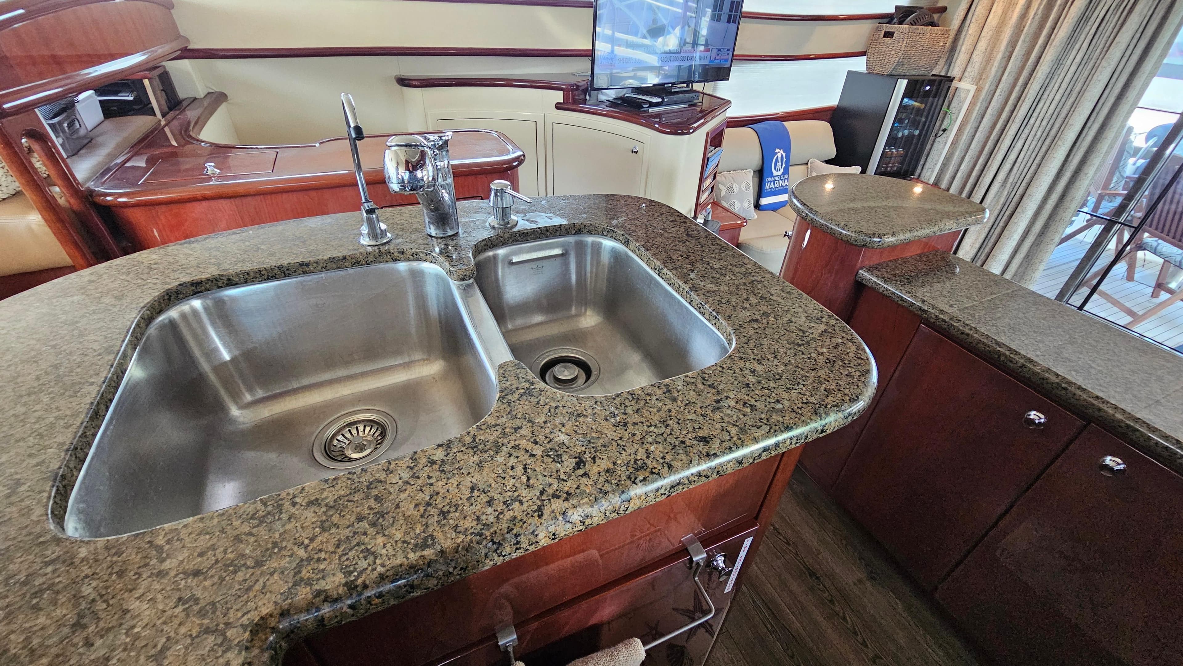 Luxurious kitchen area in 2005 Neptunus 56 Flybridge yacht with granite countertops.