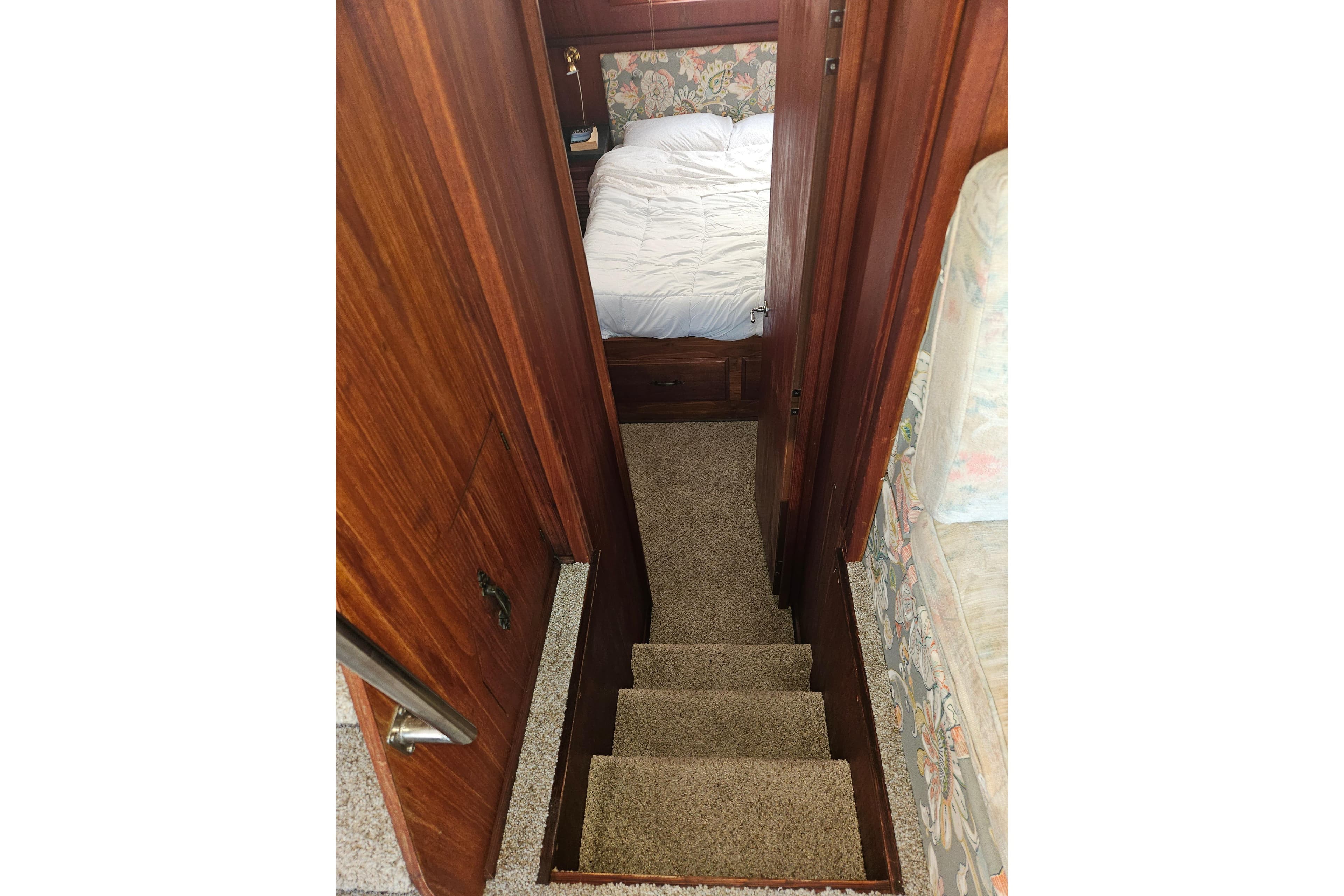 Stairway leading to cozy bedroom in 1981 Tollycraft 43 Motor Yacht.