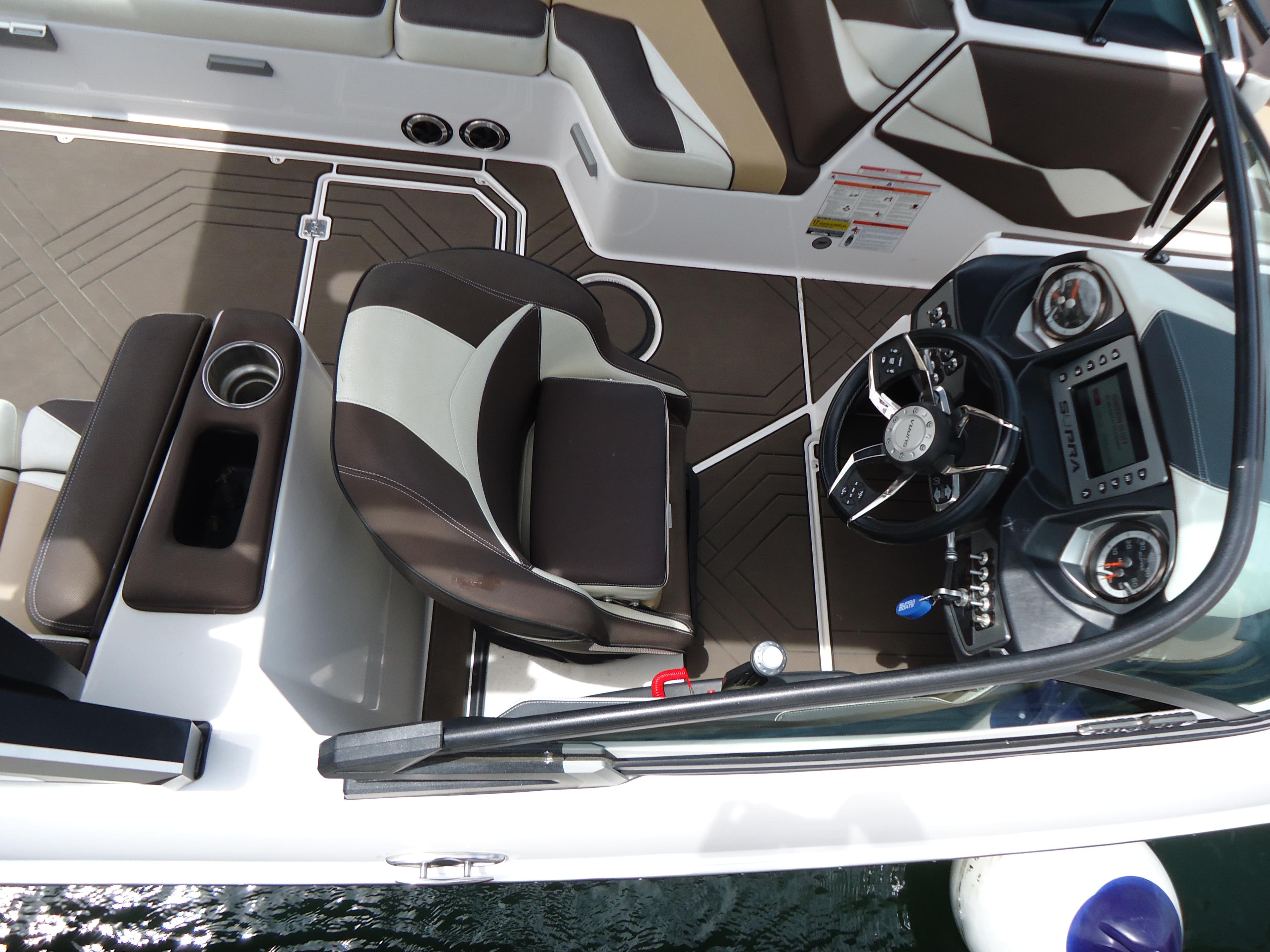 2018 Supra SL boat interior with captain's chair and dashboard.