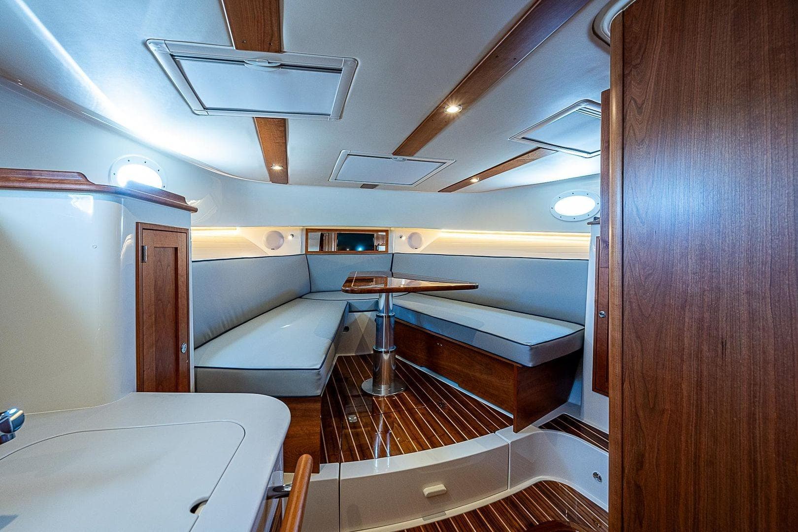 Luxurious interior of 2023 Hinckley 40x yacht with elegant wood finishes and seating area.