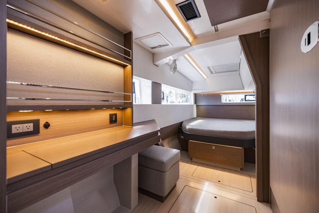 Luxurious interior of 2024 Leopard 45 yacht with modern design and cozy sleeping area.
