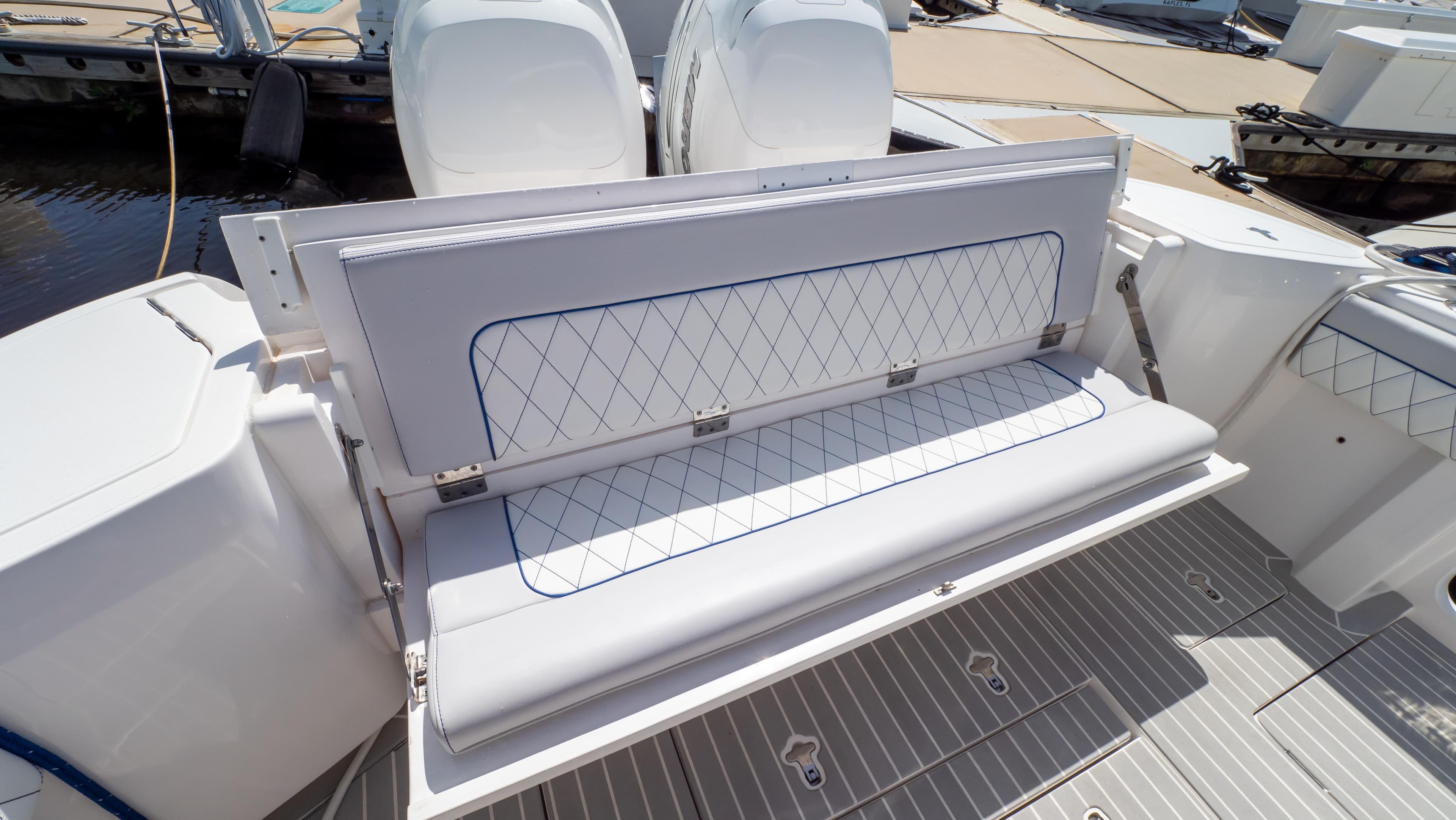 2022 Intrepid 345 Valor boat with foldable rear seating and dual outboard engines.
