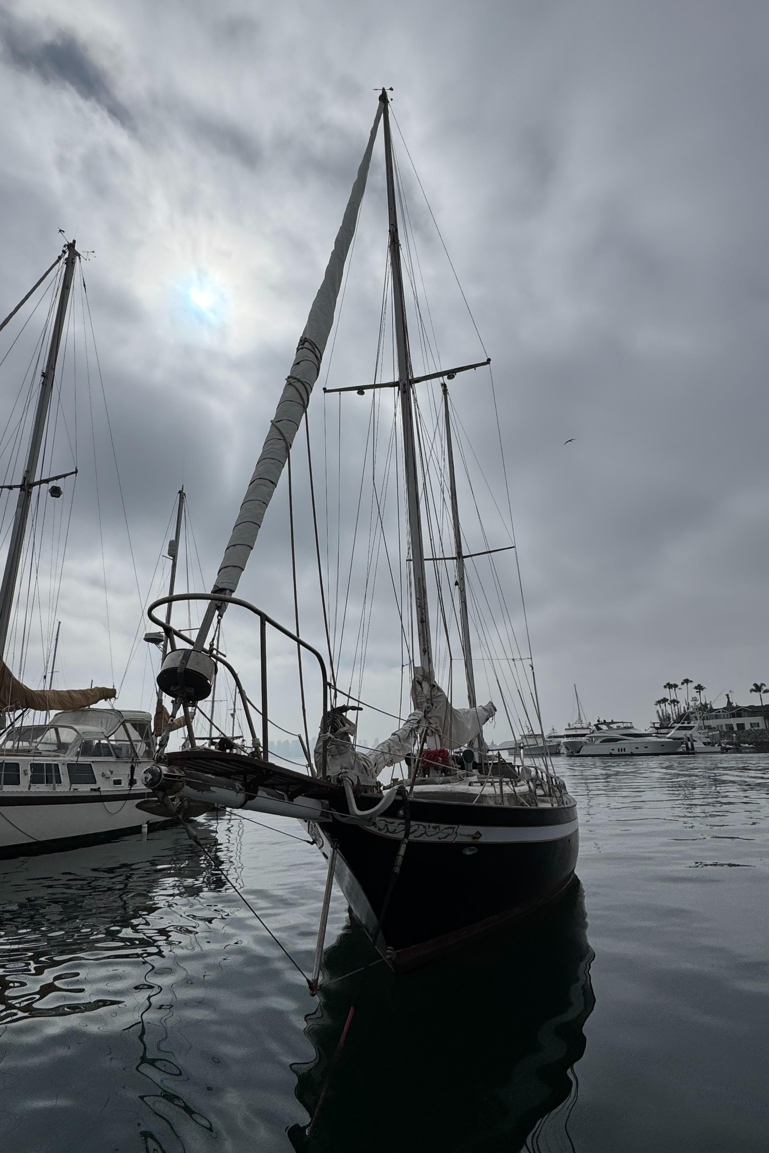1979 Cheoy Lee Bill Luders Clipper Ketch docked under cloudy skies.