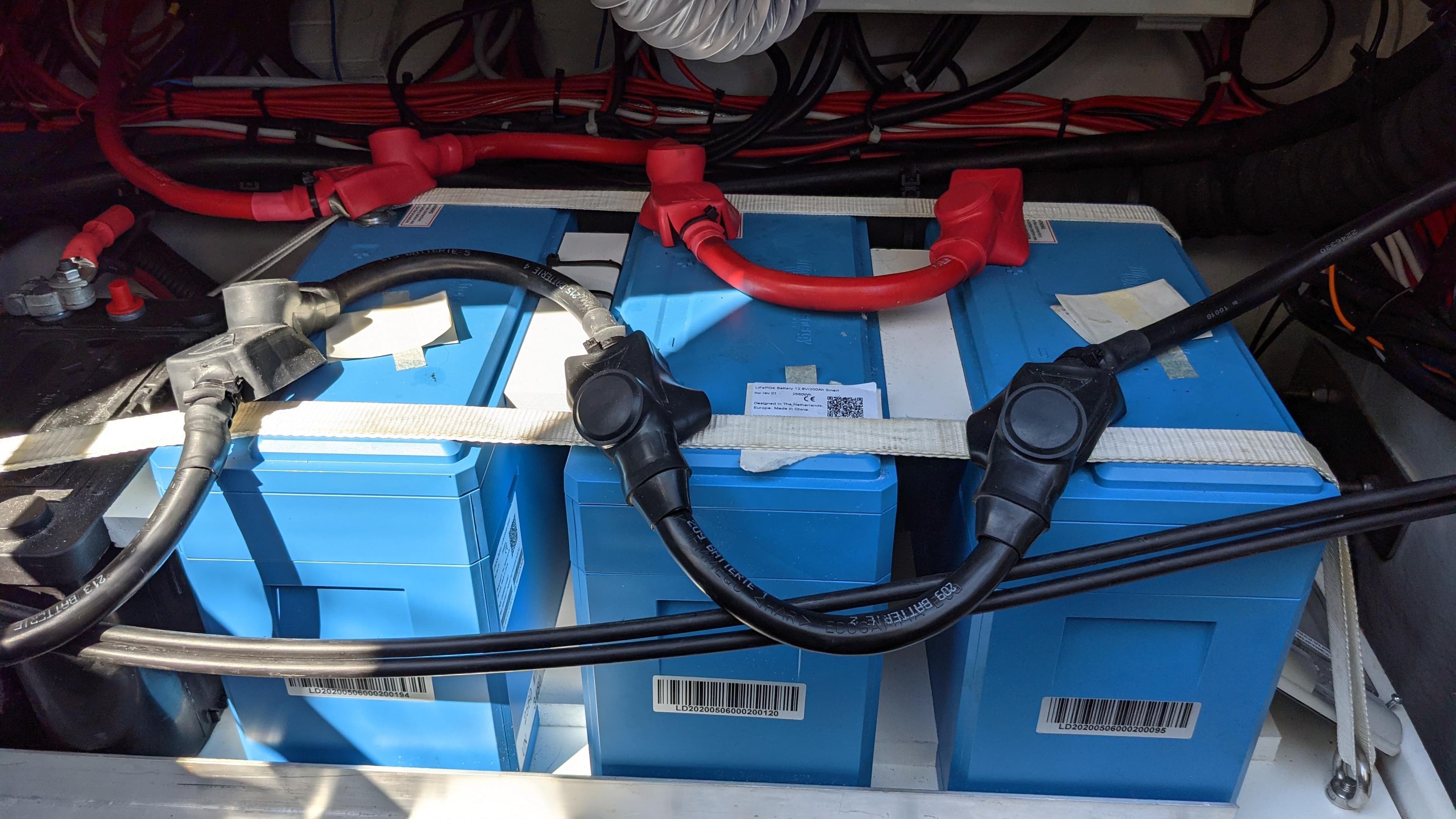 Blue batteries with cables in a 2019 Fountaine Pajot Saona 47 yacht.