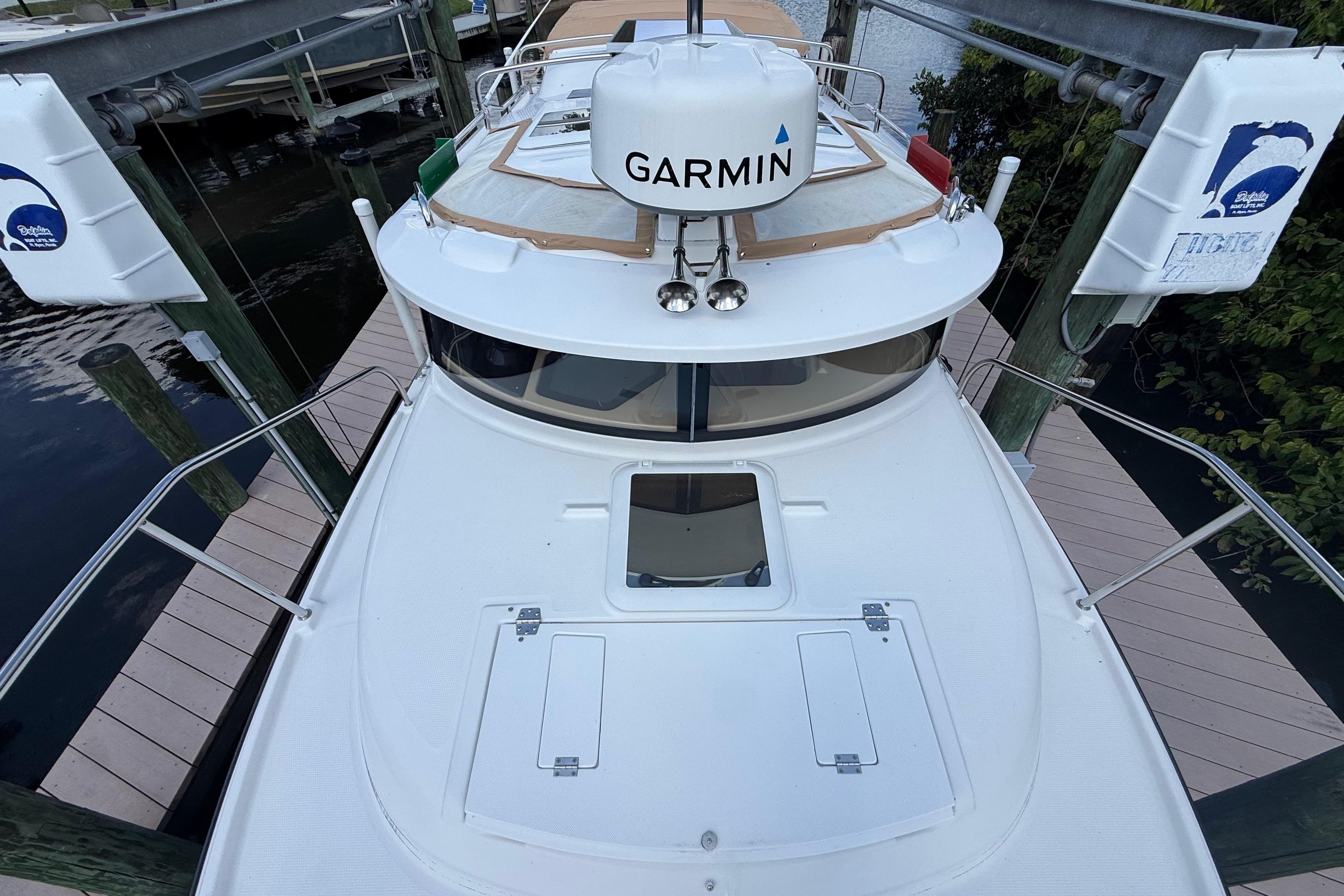 2019 Ranger Tugs R-27 boat docked, featuring Garmin equipment on deck.