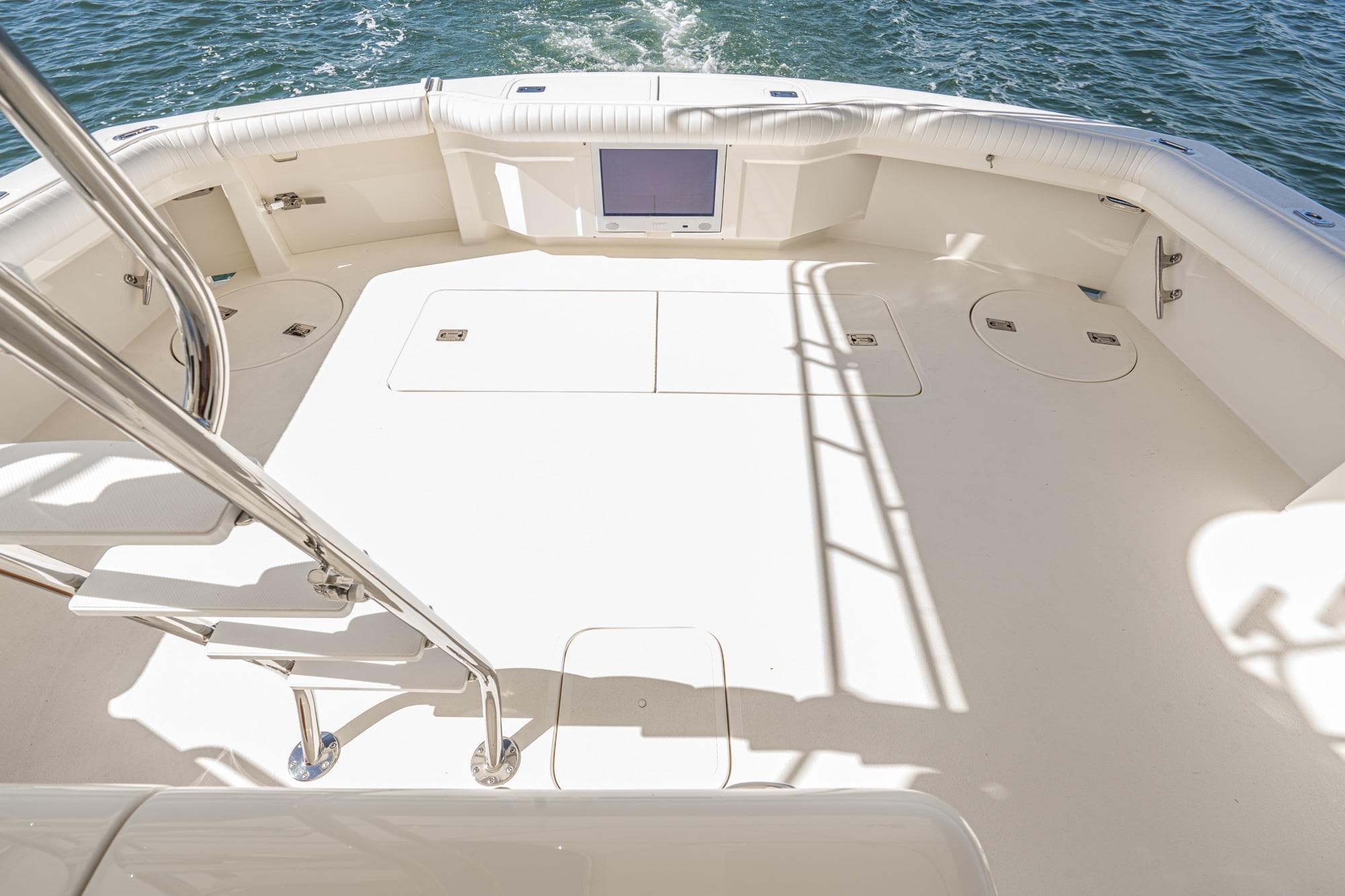 Spacious deck of 1991 Hatteras 58 Convertible yacht with ocean view.