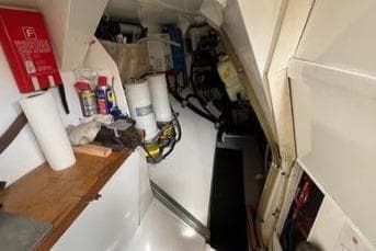Interior of 1983 Schooner Damien II, featuring storage and maintenance equipment.