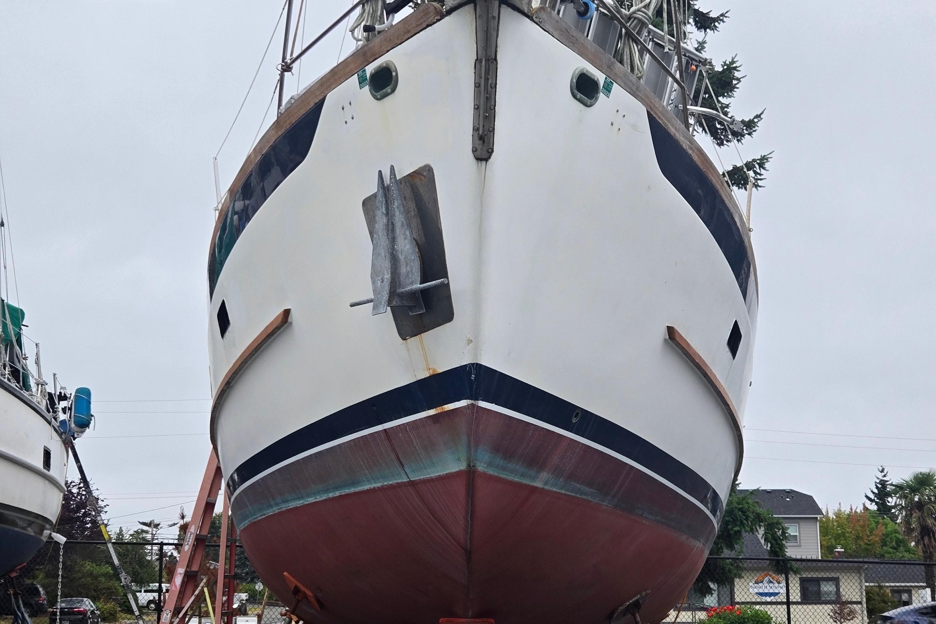 1981 Cheoy Lee 43 Pilot House sailboat on land, showcasing its hull and anchor.
