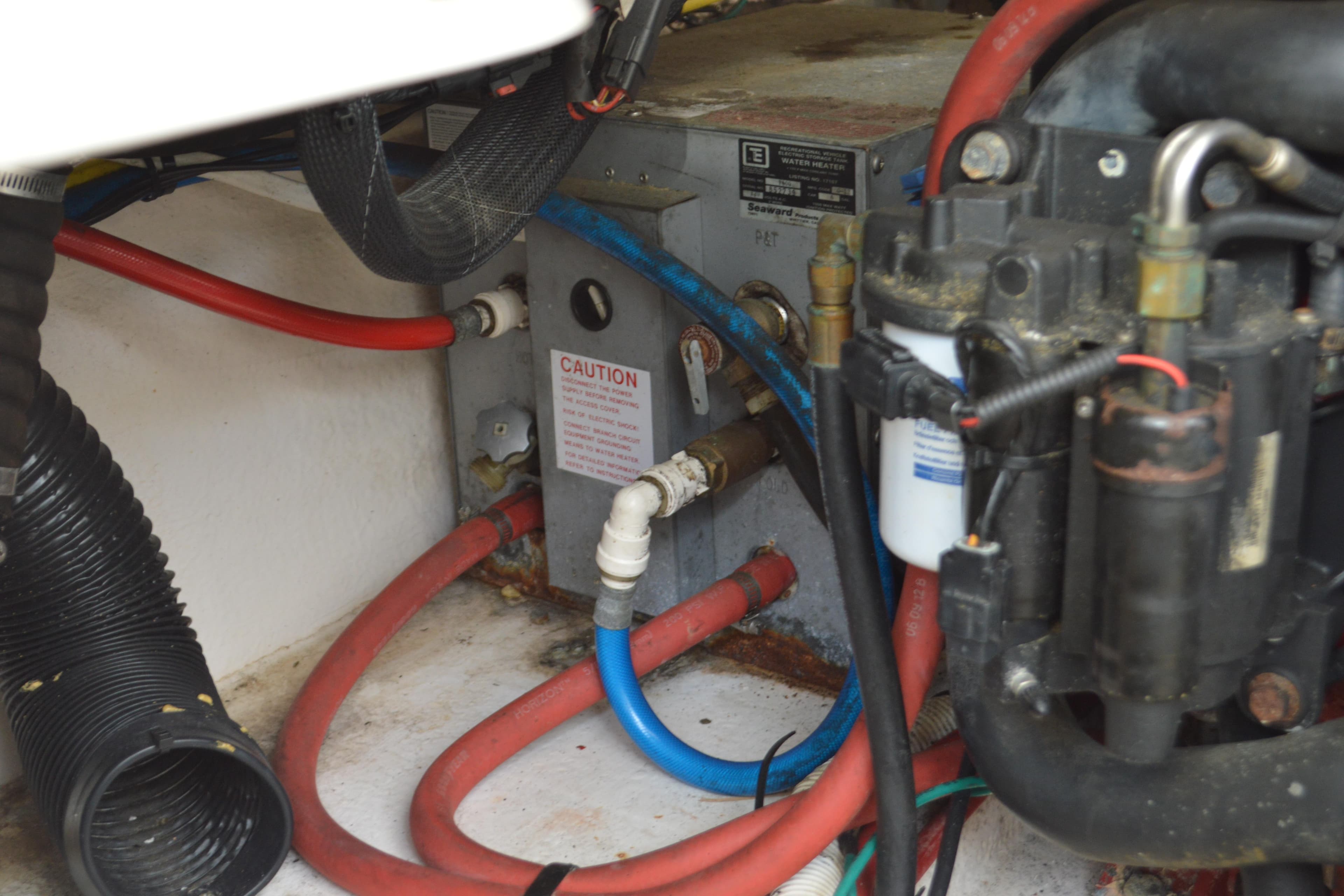 Engine compartment of 2013 Chaparral 327 SSX with visible hoses and components.