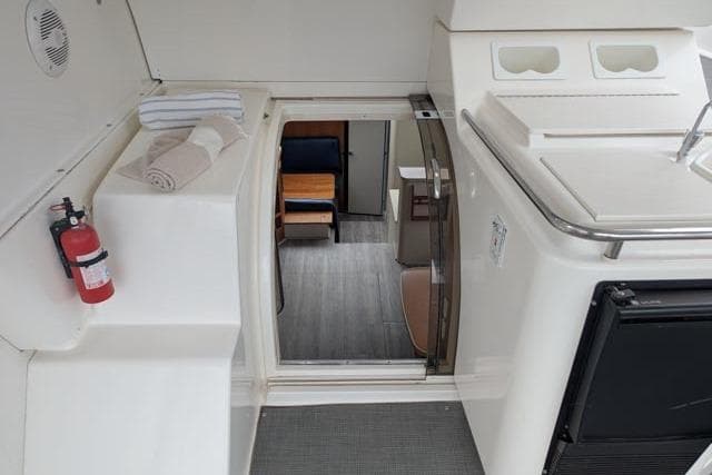 1998 Silverton 402 Motor Yacht interior with towels, fire extinguisher, and cabin view.