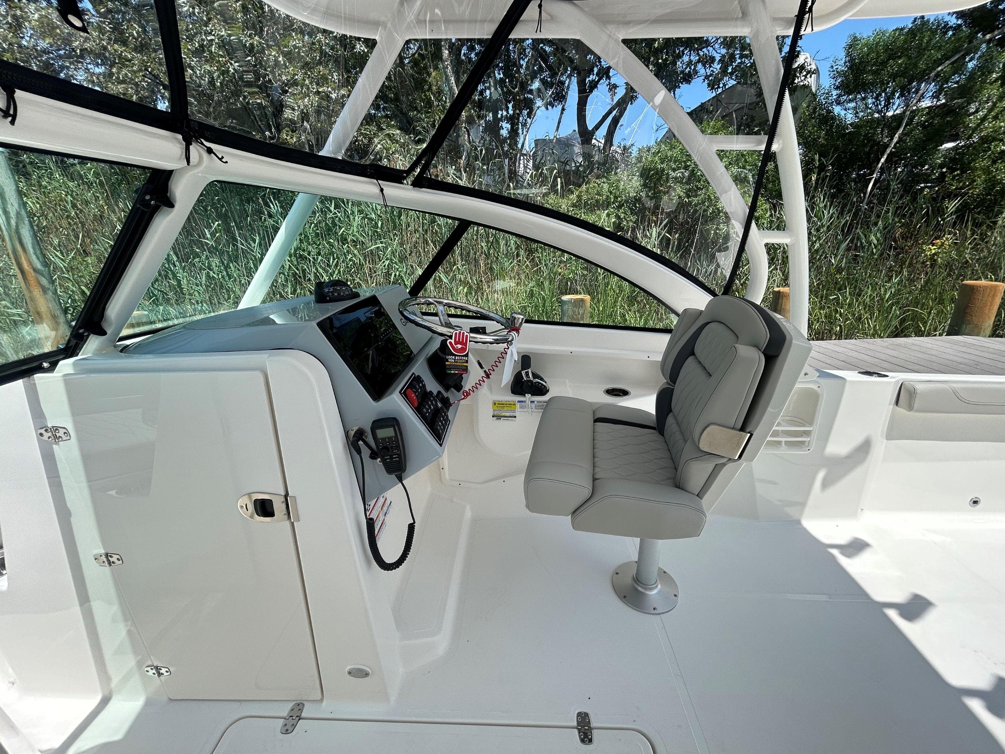 2026 Pursuit DC 246 Dual Console boat interior with helm and seating.