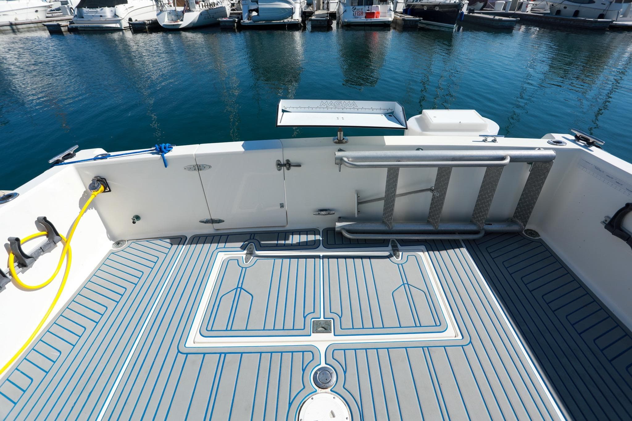 1988 Mediterranean 38 Convertible boat deck with ladder and water hose at marina.