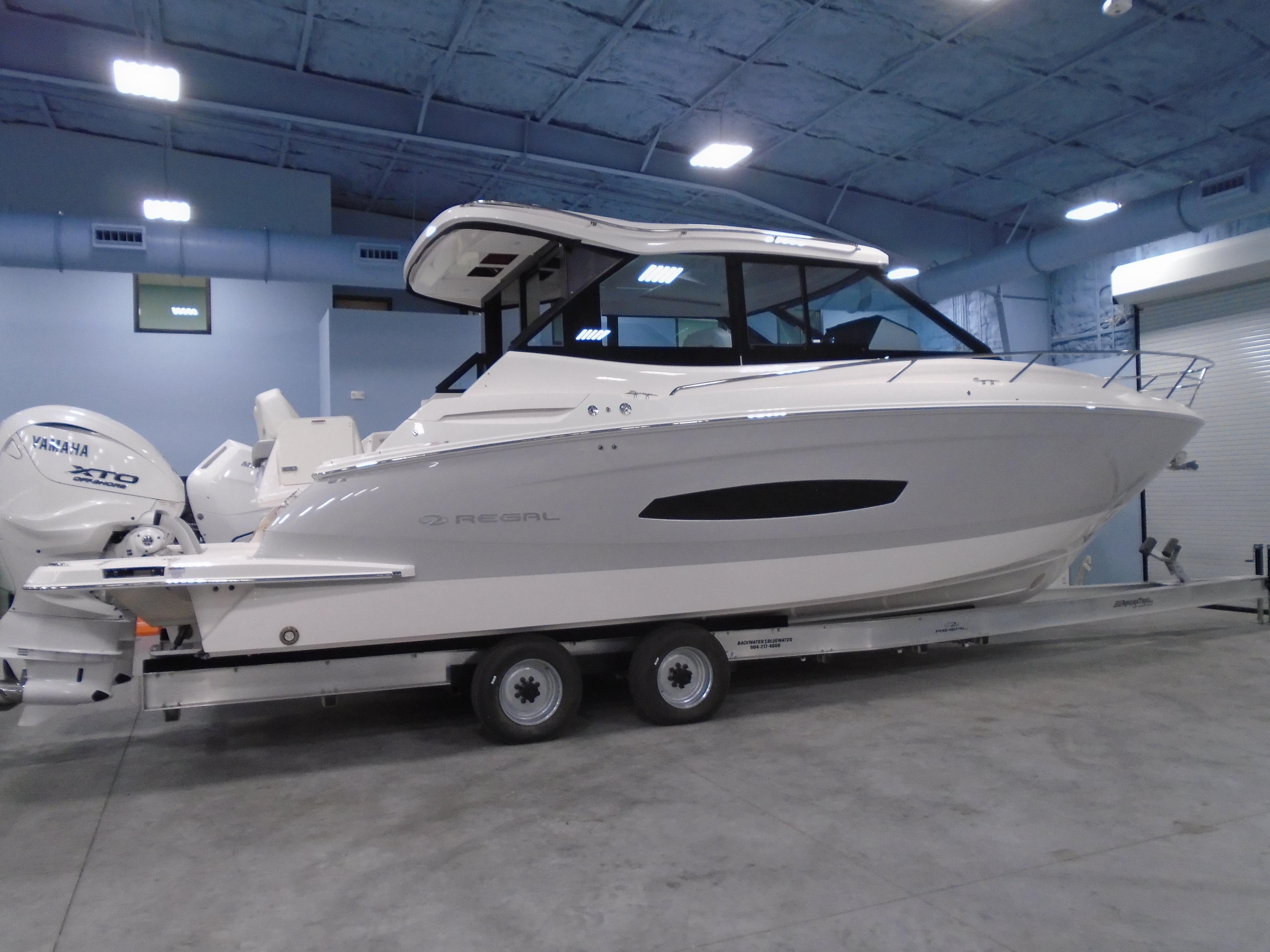 2024 Regal 36XO boat on trailer in indoor storage facility.