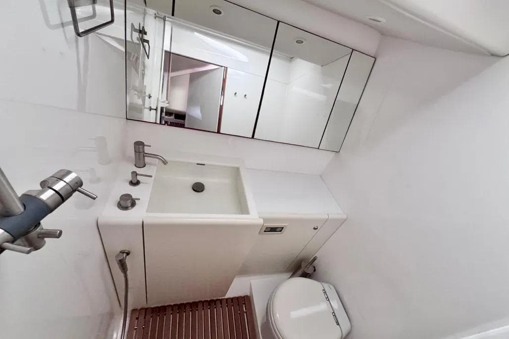 Luxurious bathroom in 2009 Nautor Swan 60 FD yacht with modern fixtures and mirrors.