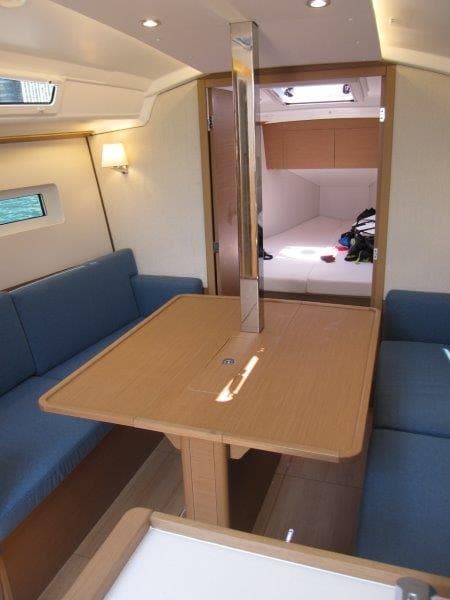 Interior of 2025 Jeanneau Sun Odyssey 350 sailboat with cozy seating and dining area.