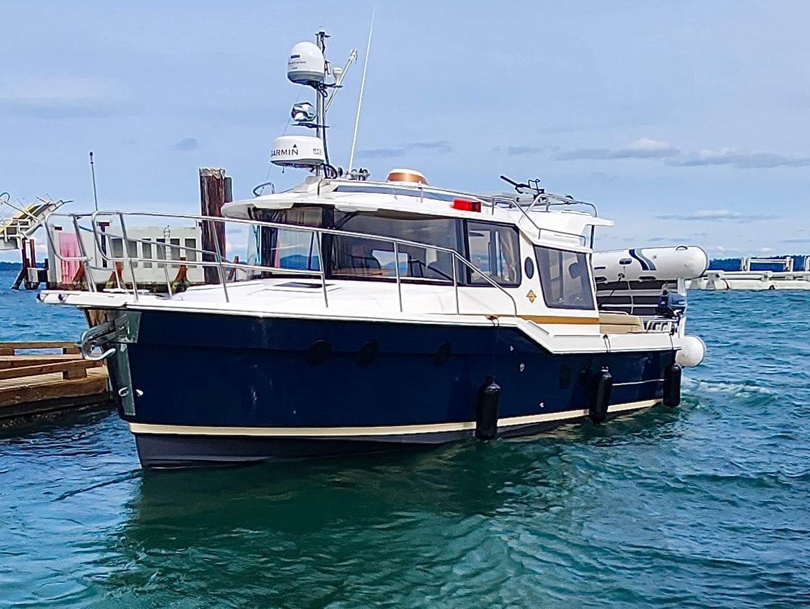 2023 Ranger Tugs R-29 S docked, blue water.