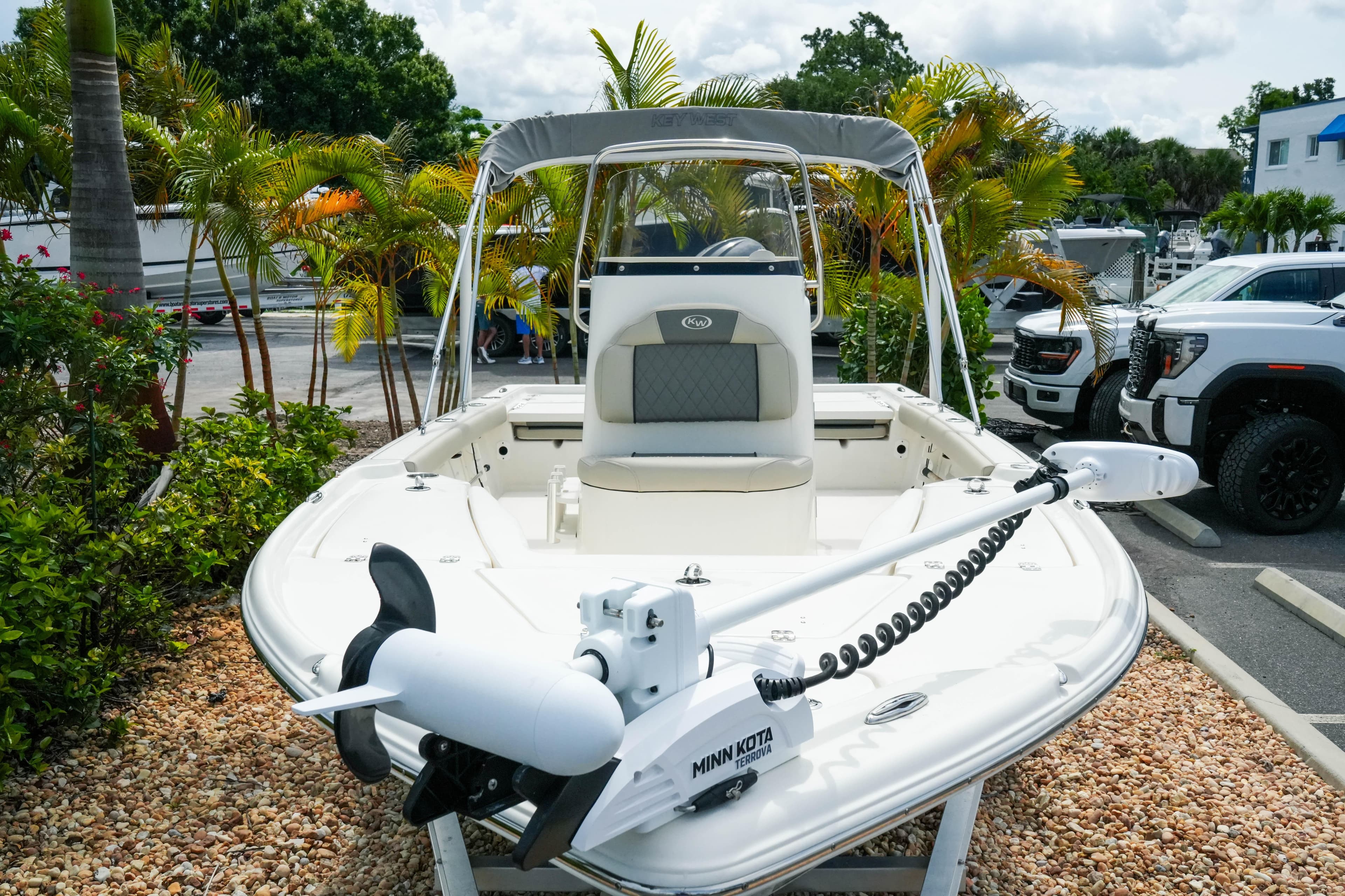 2025 Key West 210 Bay Reef boat with Minn Kota motor, parked outdoors.