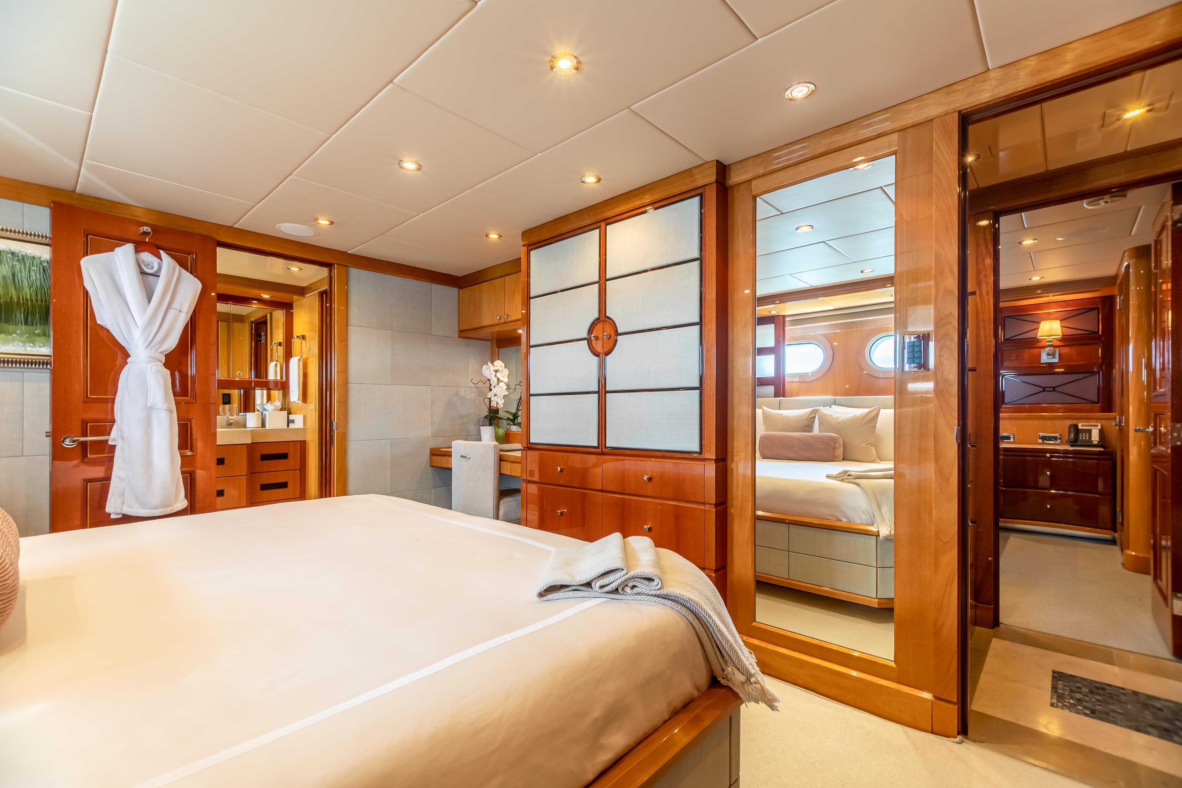 Luxurious bedroom interior of 2011 Trinity Yachts CUSTOM model with wooden accents and modern amenities.