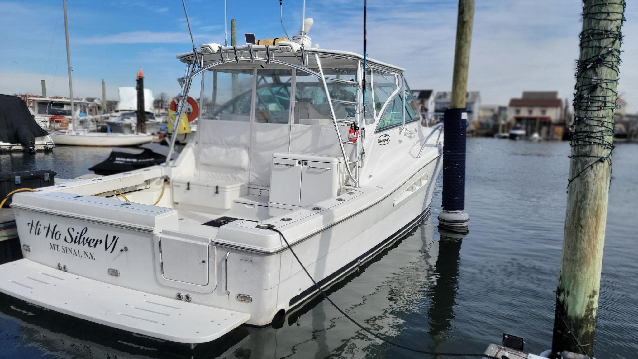 2011 Rampage 41 Express boat docked in marina, rear view.
