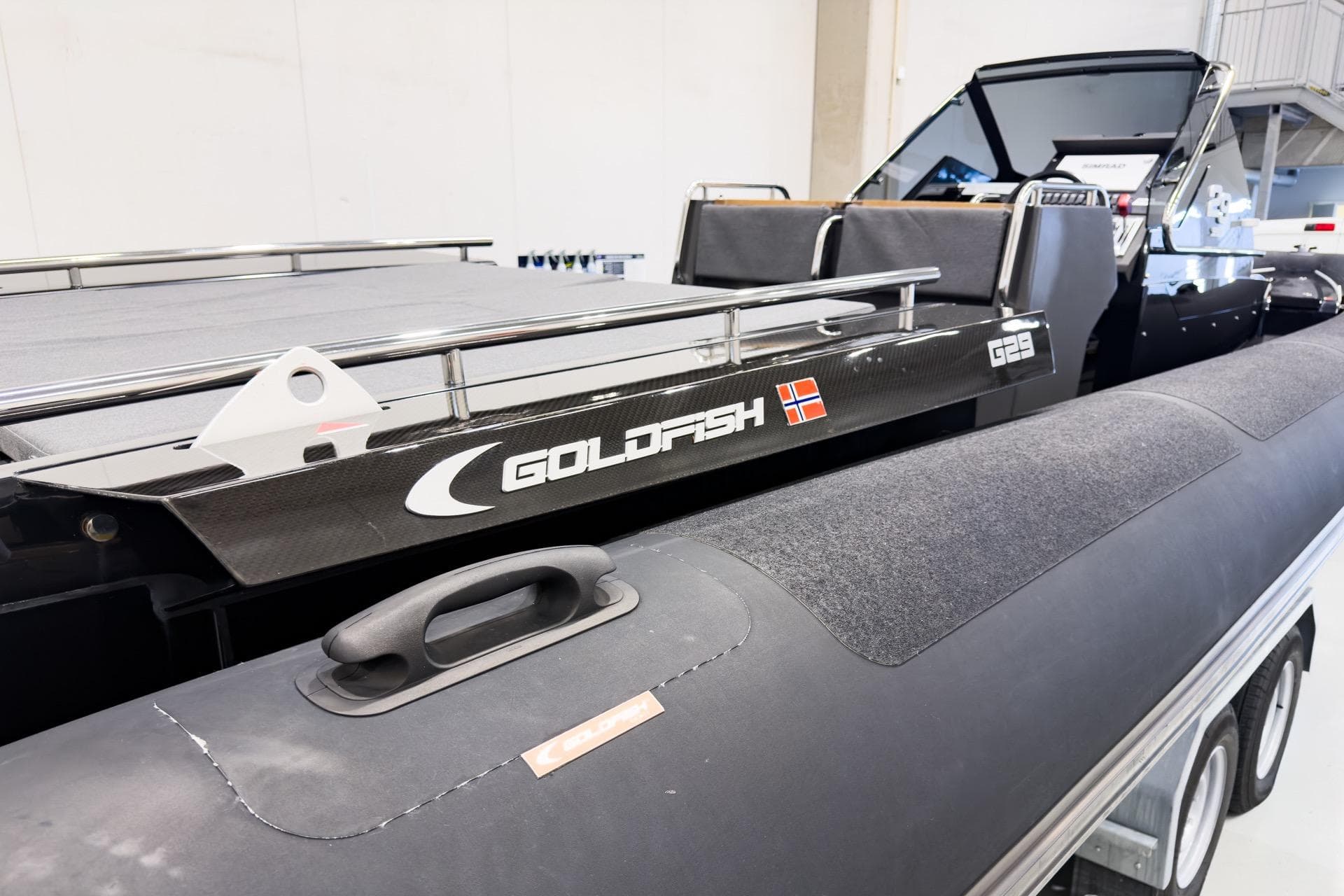 2016 Goldfish 29 Sport boat with sleek design and Norwegian flag emblem.